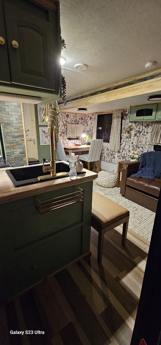 Step inside this charming RV rental, showcasing a modern kitchen, cozy dining nook, and comfortable living area with warm decor.. Forest River Rockwood Signature Ultra Lite 2011