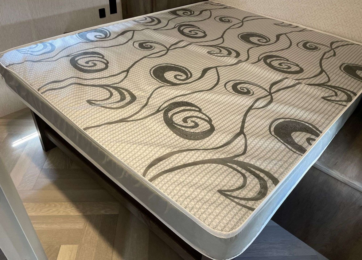 This RV rental mattress features a comfortable gray swirl and geometric pattern, ready for your next adventure.. Forest River Evo T2400BHXW 2022