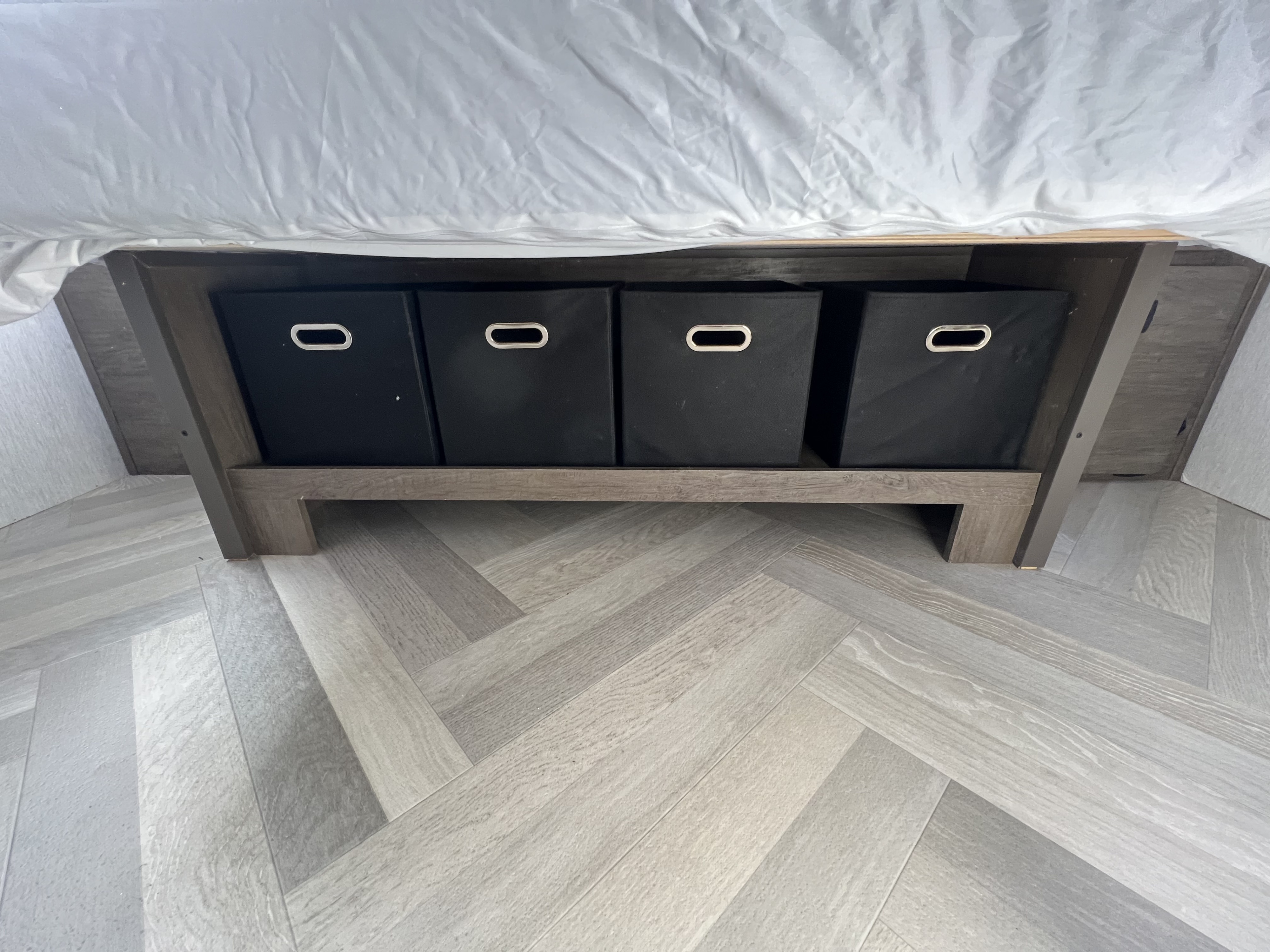 RV rental: Under-bed storage with four black bins offers organized space. Modern herringbone flooring visible.. Forest River Salem Cruise Lite 2022