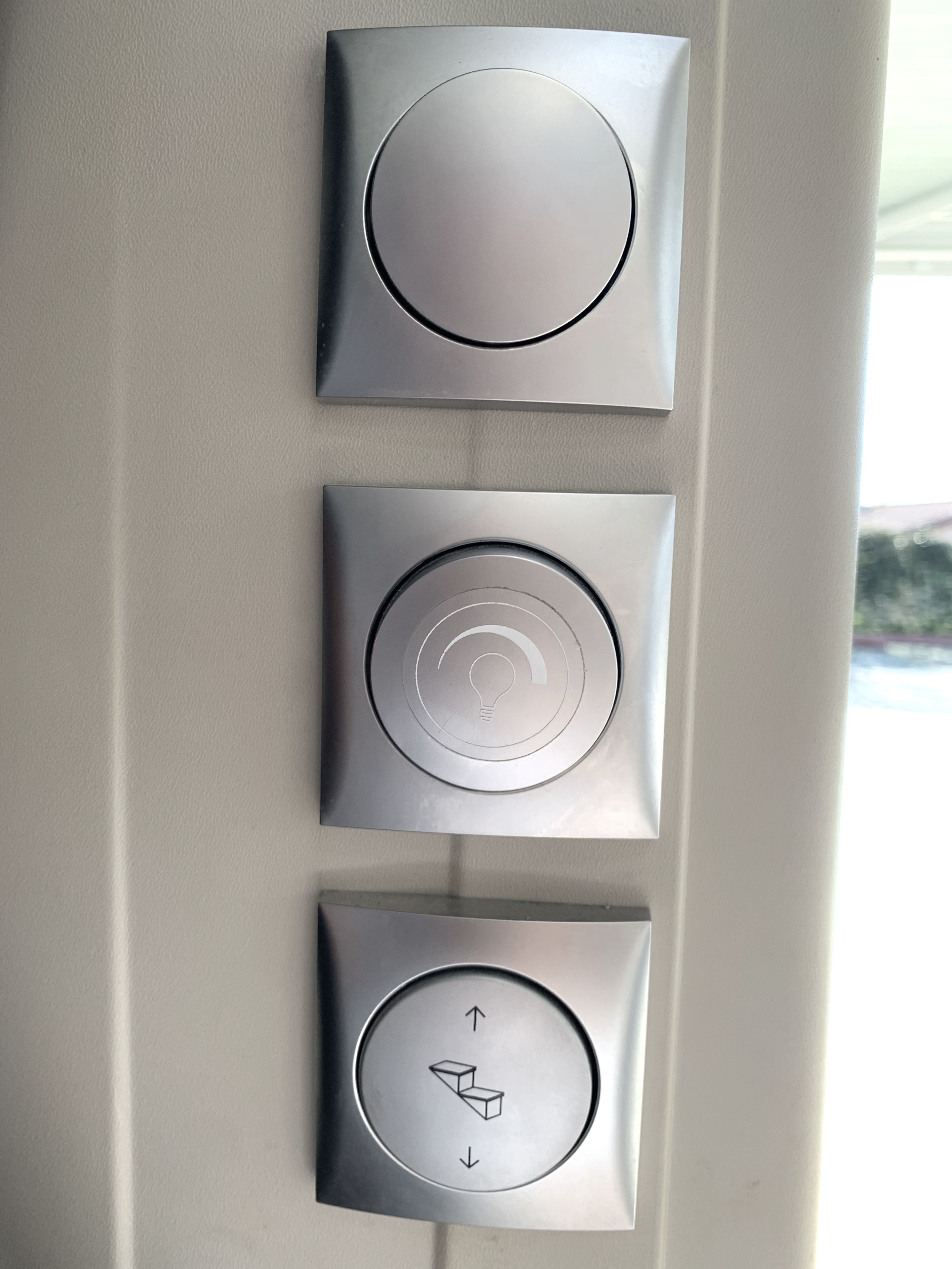 RV rental: Sleek silver interior controls. One button for light dimming, another for automatic entry steps.. Adria Twin Axess 600 SP 2022