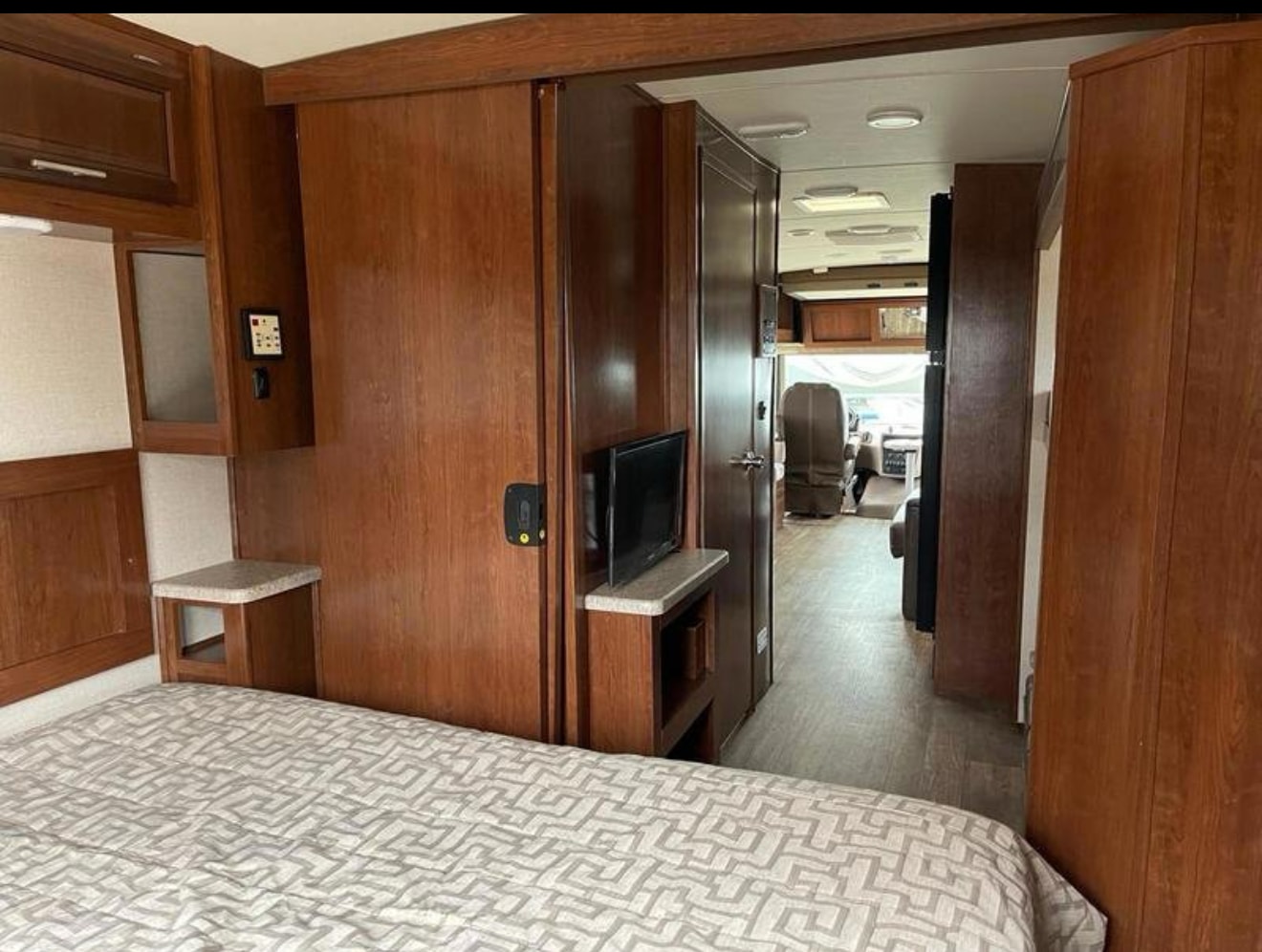 RV rental interior: View from the bedroom towards the hallway and front living area/cockpit, featuring warm wood cabinetry.. FR3 FR3 Motorhome 2017