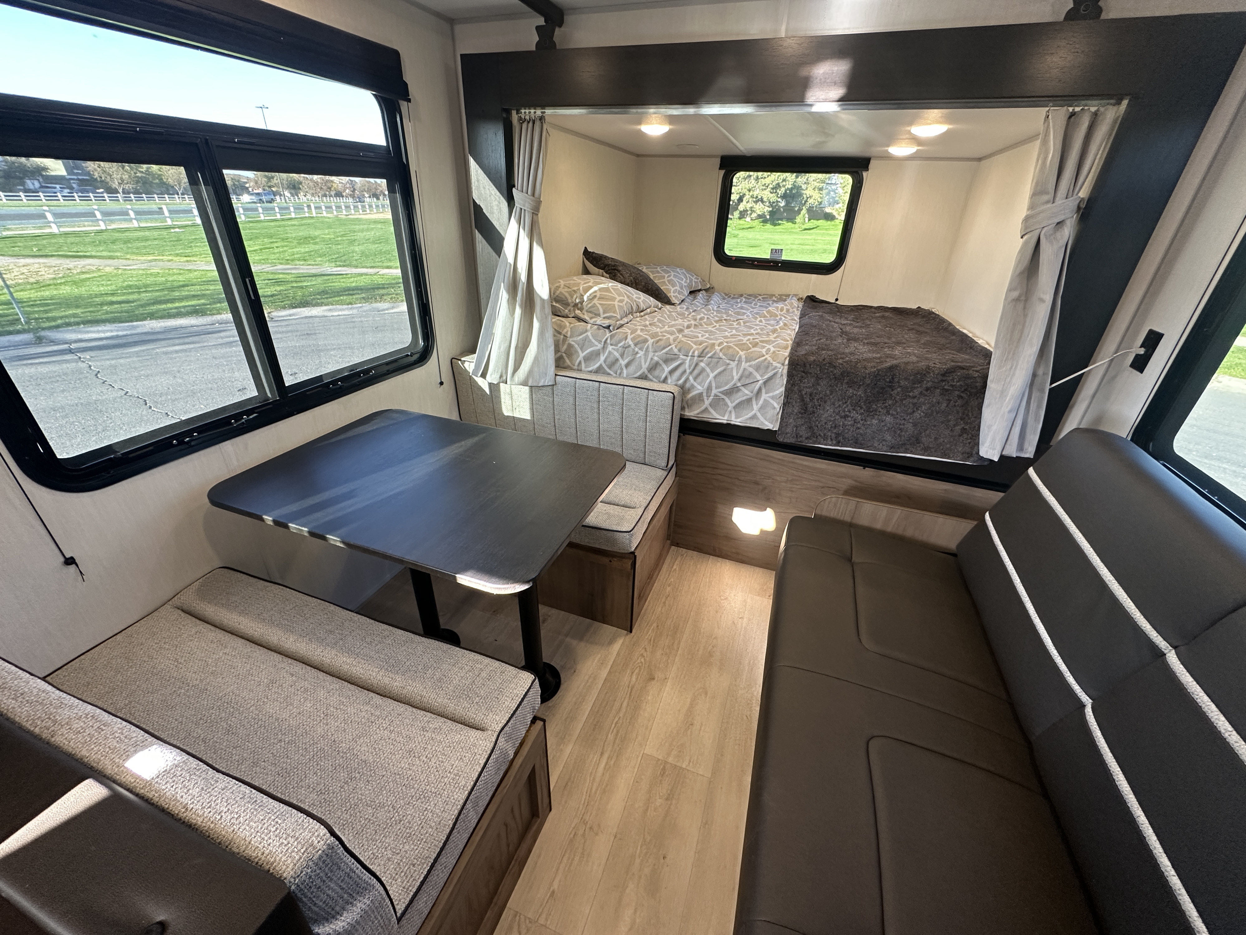 Step inside this modern rv rental: a cozy dinette, comfortable bed, and scenic window views await.. Forest River Cherokee 2025