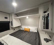 Spacious RV rental bedroom with a comfortable queen bed, modern built-in storage, and ambient lighting for your travels.. Highland Ridge Wayfinder GoPlay 26BHS 2025