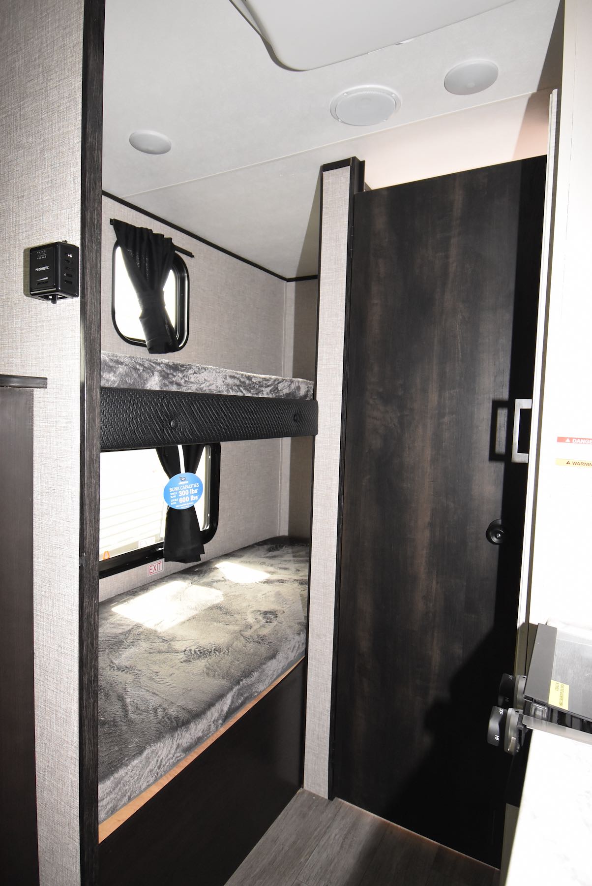 RV rental interior: inviting bunk beds with windows, perfect for family travel trailer or camper adventures. Features charging port.. Jayco Jay Flight SLX 2022