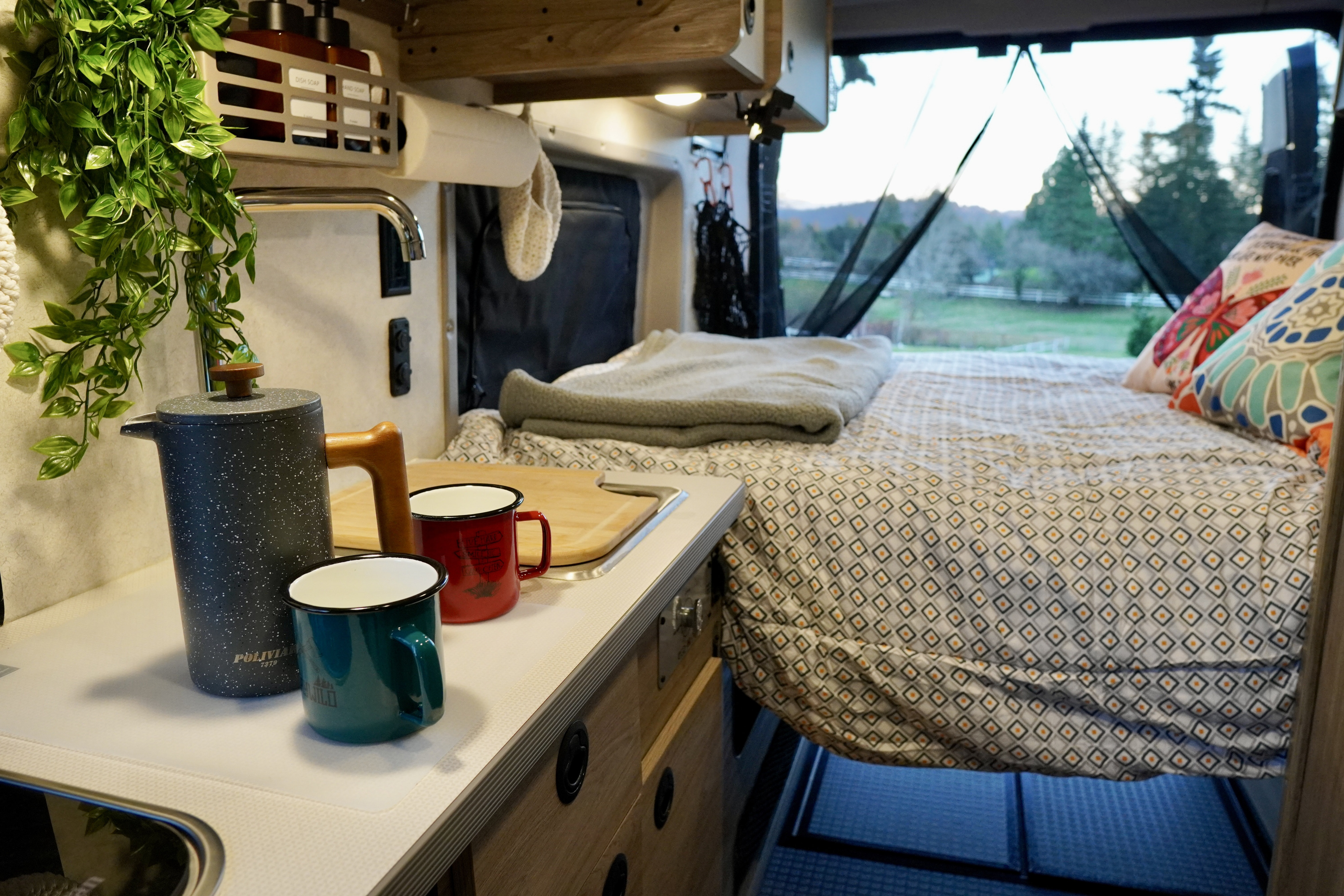 Cozy interior of an RV rental with kitchen area and comfortable bed, perfect for your next road trip adventure.. Winnebago Solis 59PX 2025