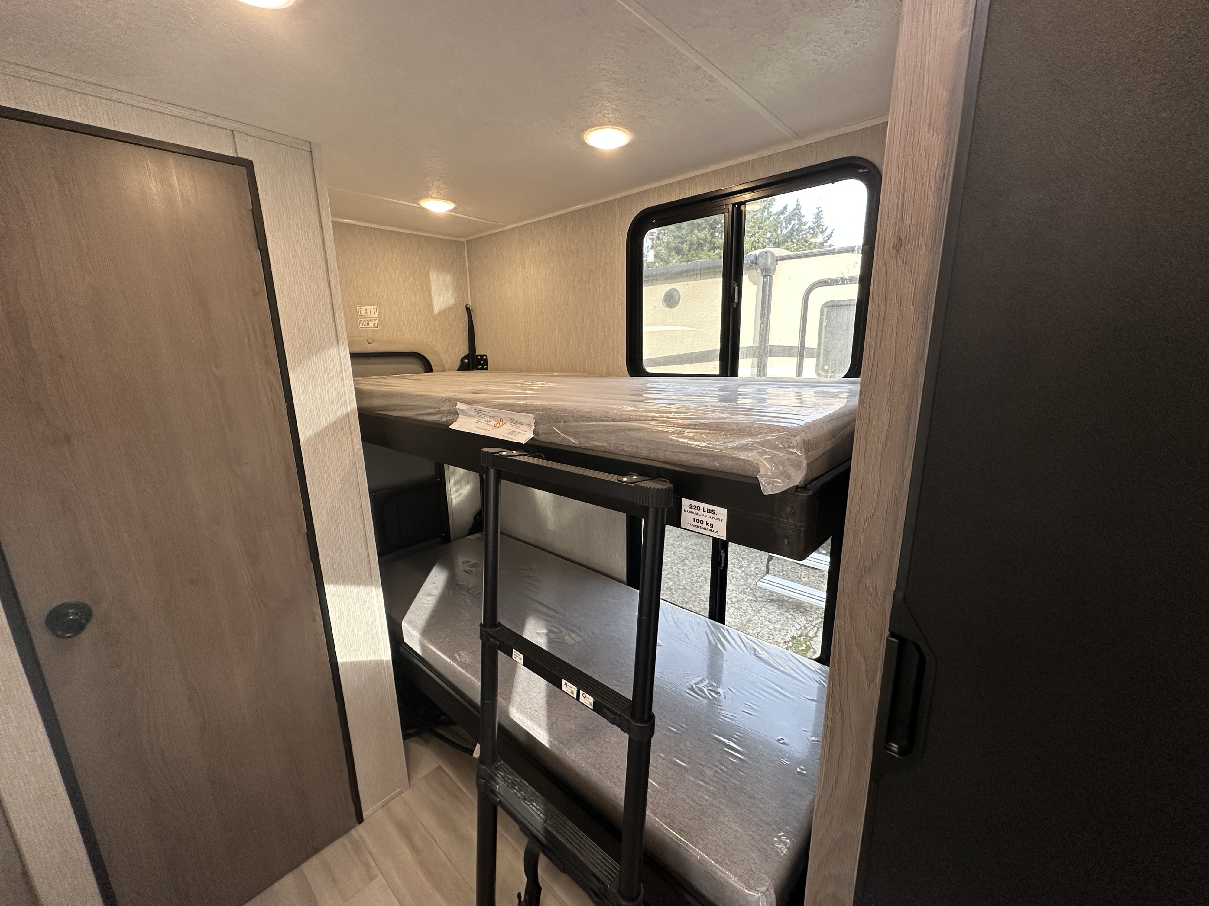 RV rental bunk beds with new mattresses and ladder. Compact interior of a family-friendly travel trailer.. Coachmen Cross Trail 20BHTA 2023