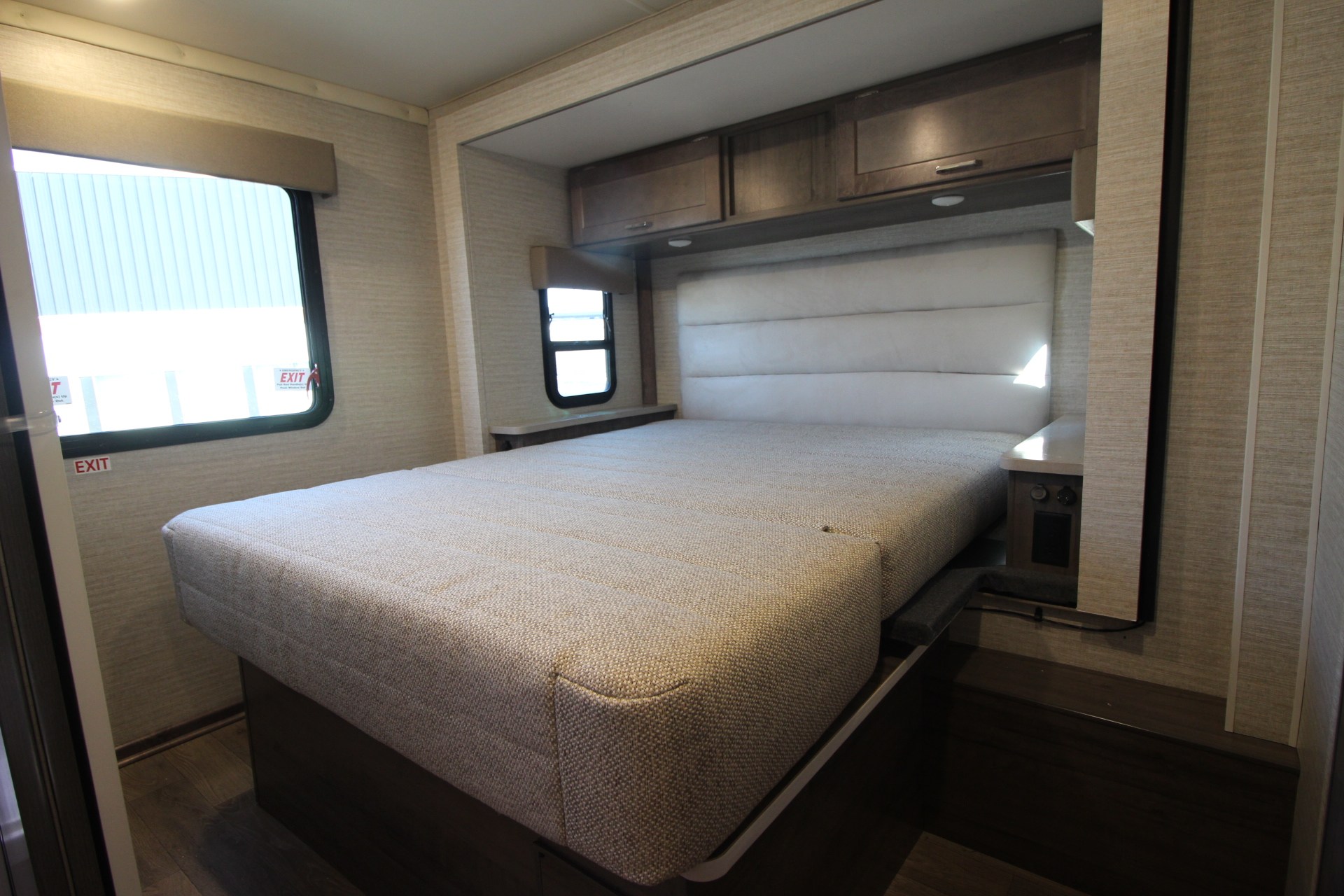 RV rental bedroom: Features a space-saving convertible bed, padded headboard, overhead storage, and windows. Cozy travel.. Winnebago Spirit 26 T 2025