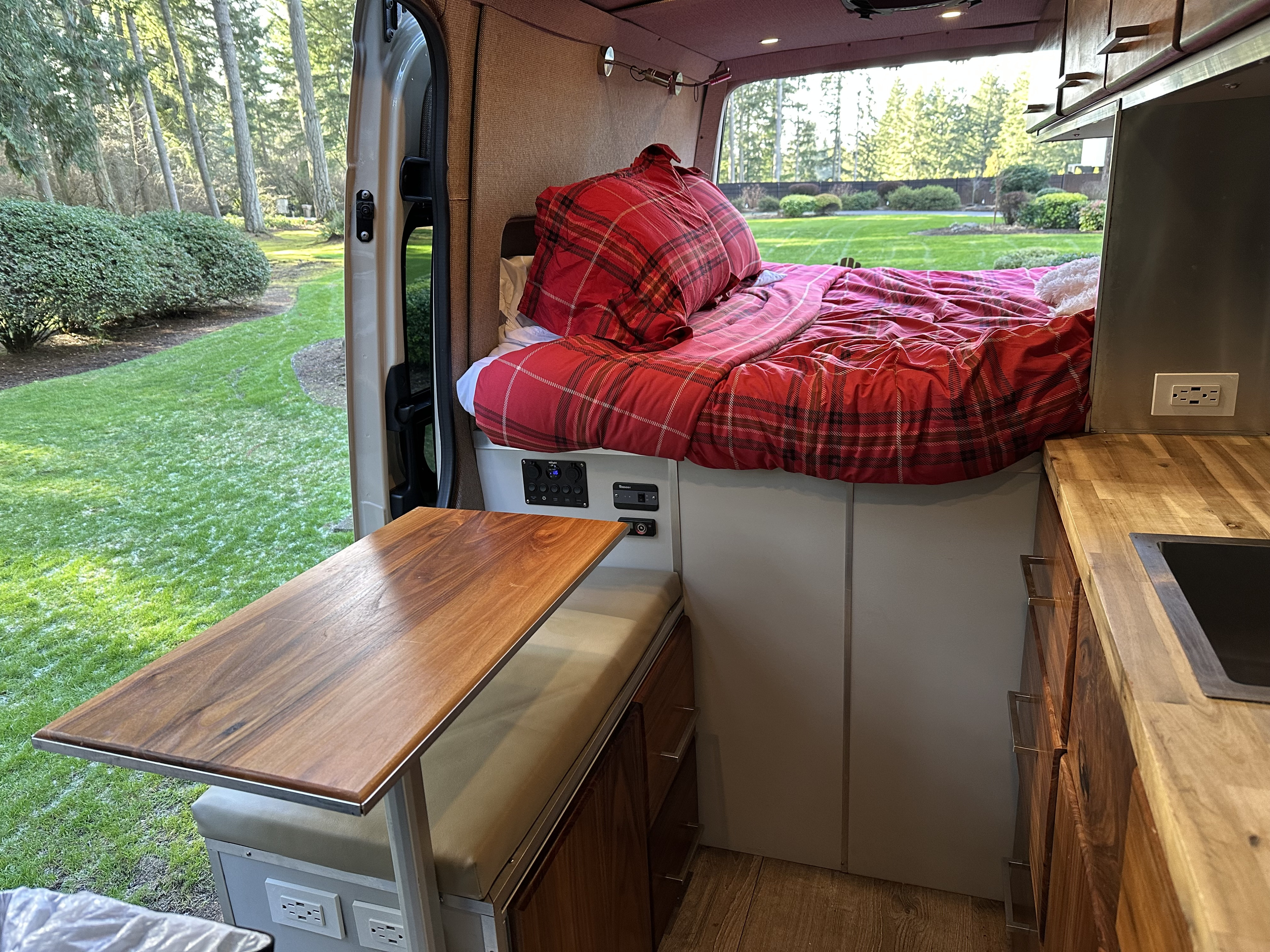Experience comfort in this rv rental! Features a plush bed, dining table, kitchen, and scenic outdoor views from inside.. Mercedes-Benz Sprinter 2022