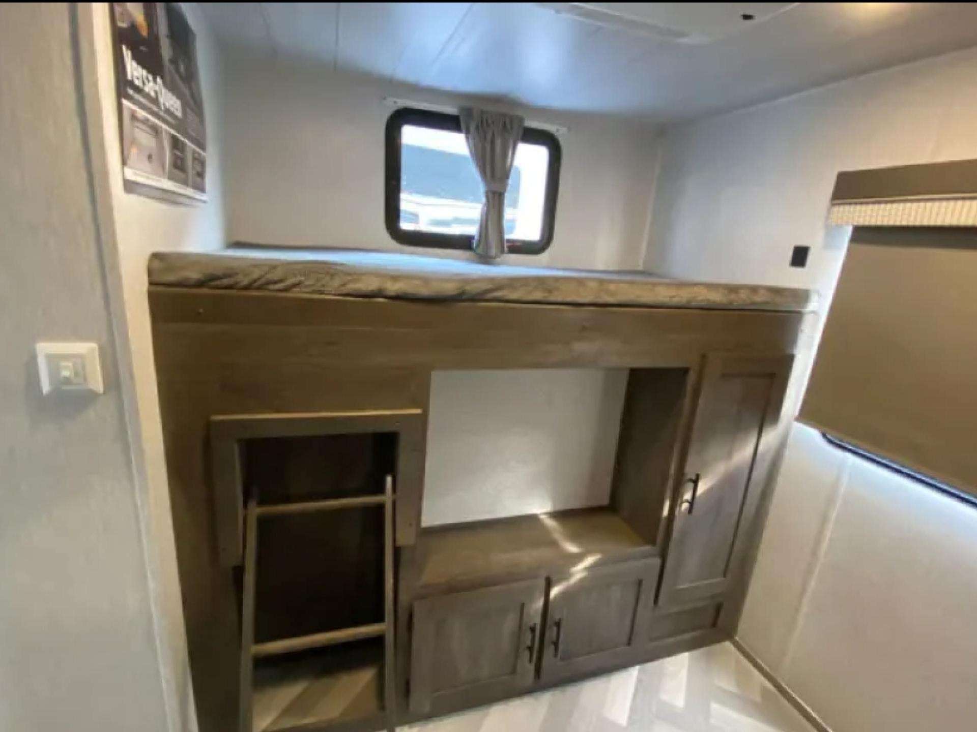 RV rental shows bunk bed, lower storage unit with ladder, and window for cozy travel.. Forest River Salem 2022