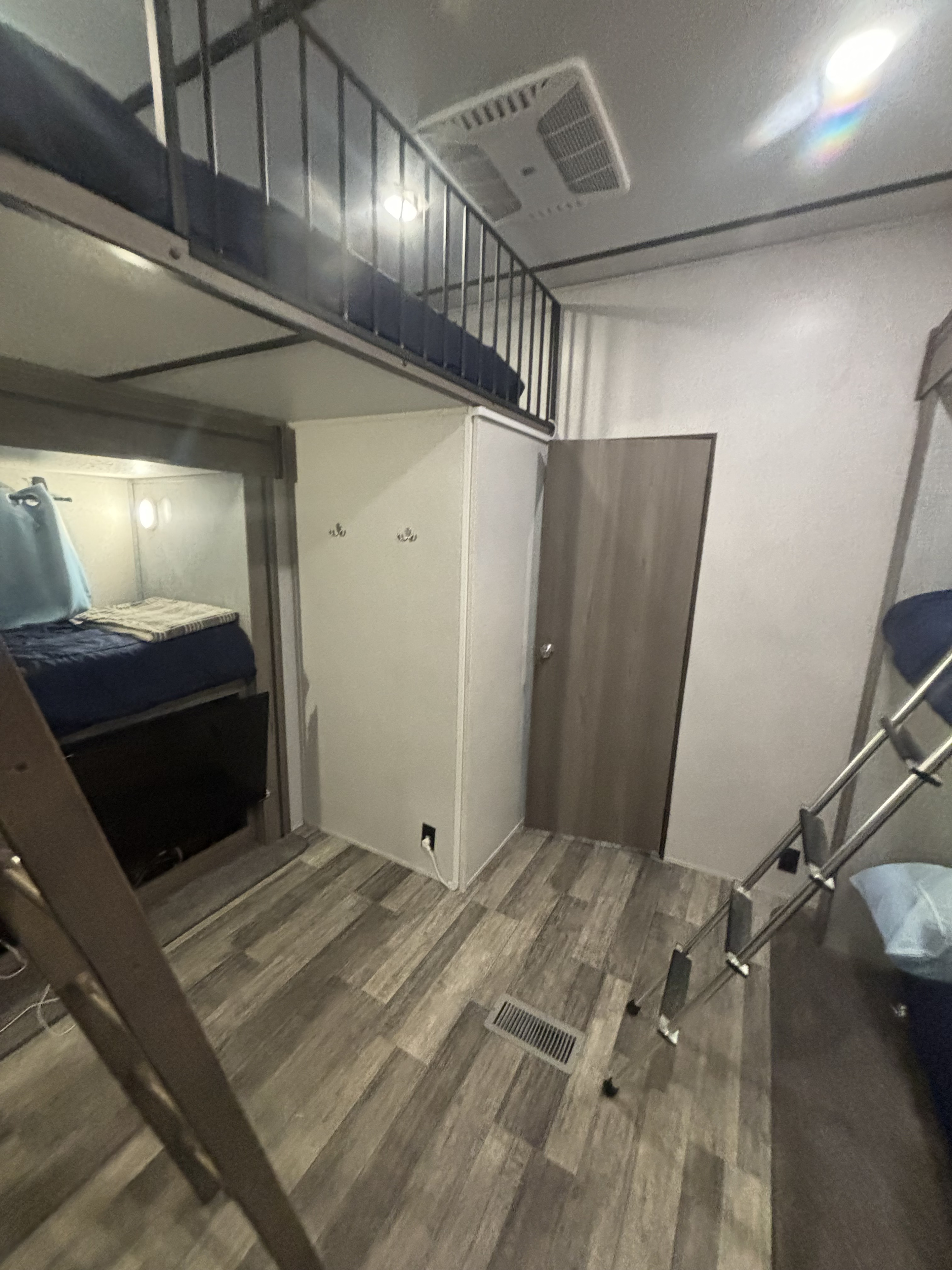 Cozy rv rental bunkhouse featuring tiered beds, built-in storage, and bright interior.. Keystone Vilante 2021