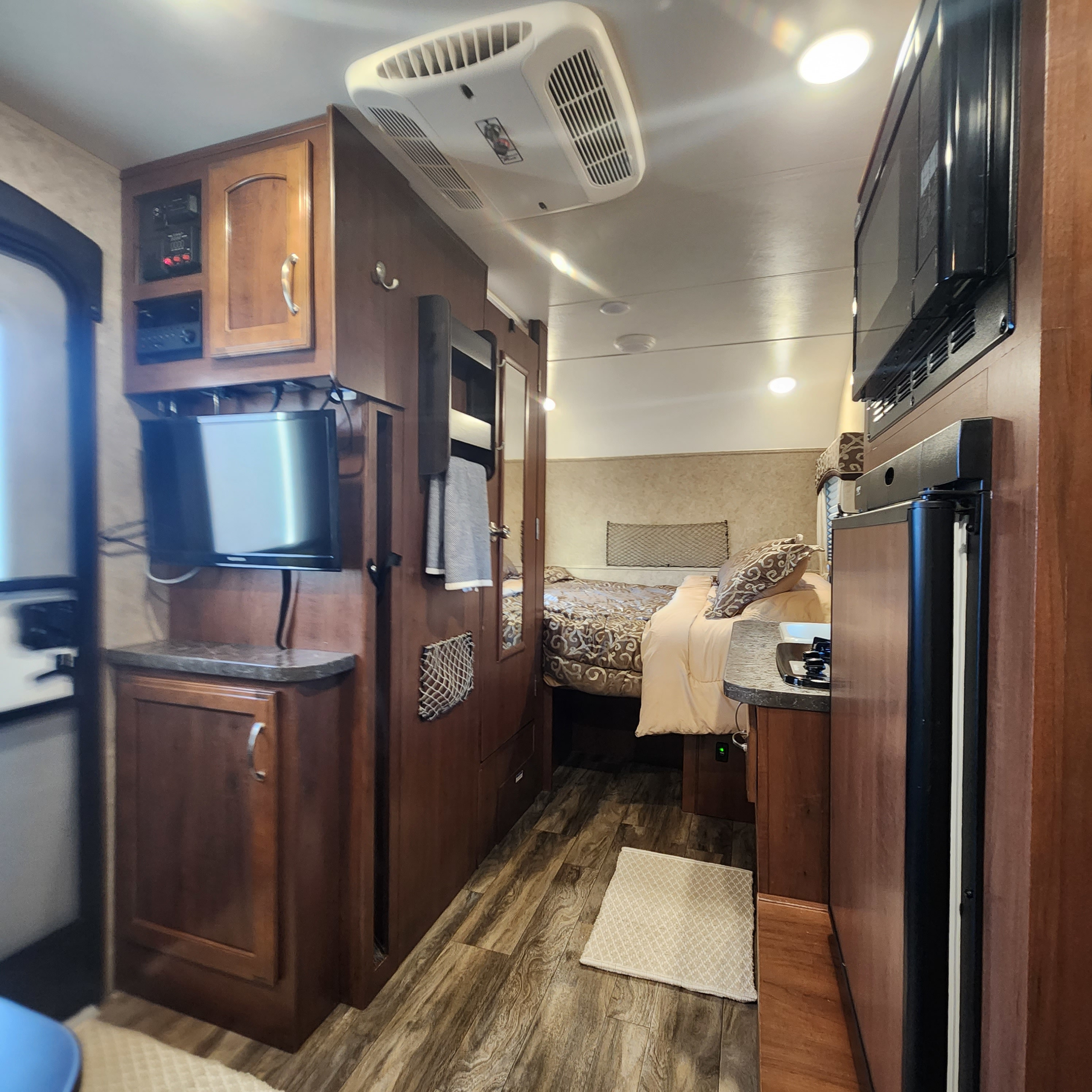 Inside an rv rental: View of the complete living space, including a kitchen, entertainment center, and cozy bedroom.. Jayco Hummingbird 2017