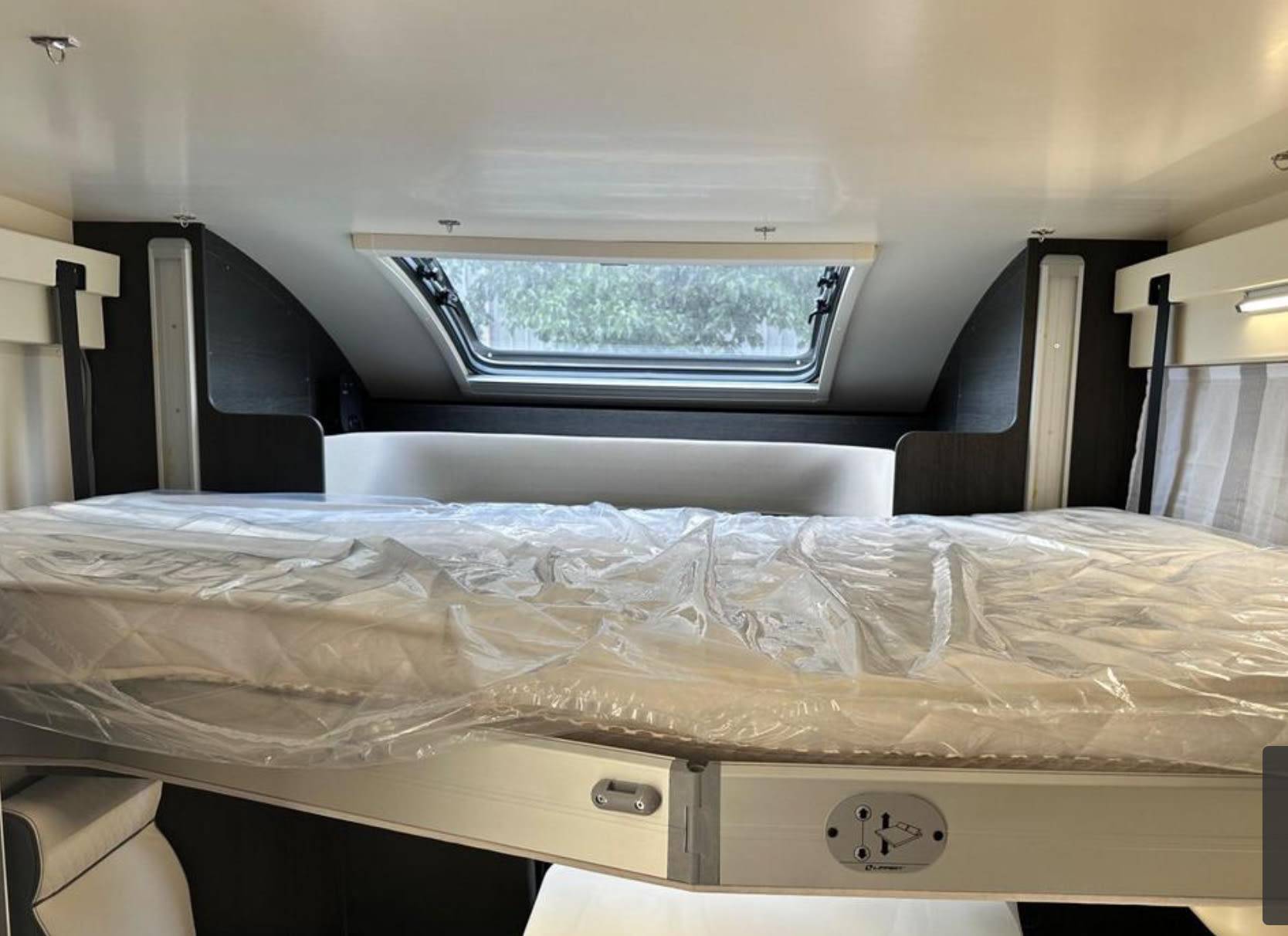 RV rental sleeping area with new drop-down bed and skylight. Clean camper interior.. Bailey Adamo 69/2 2021