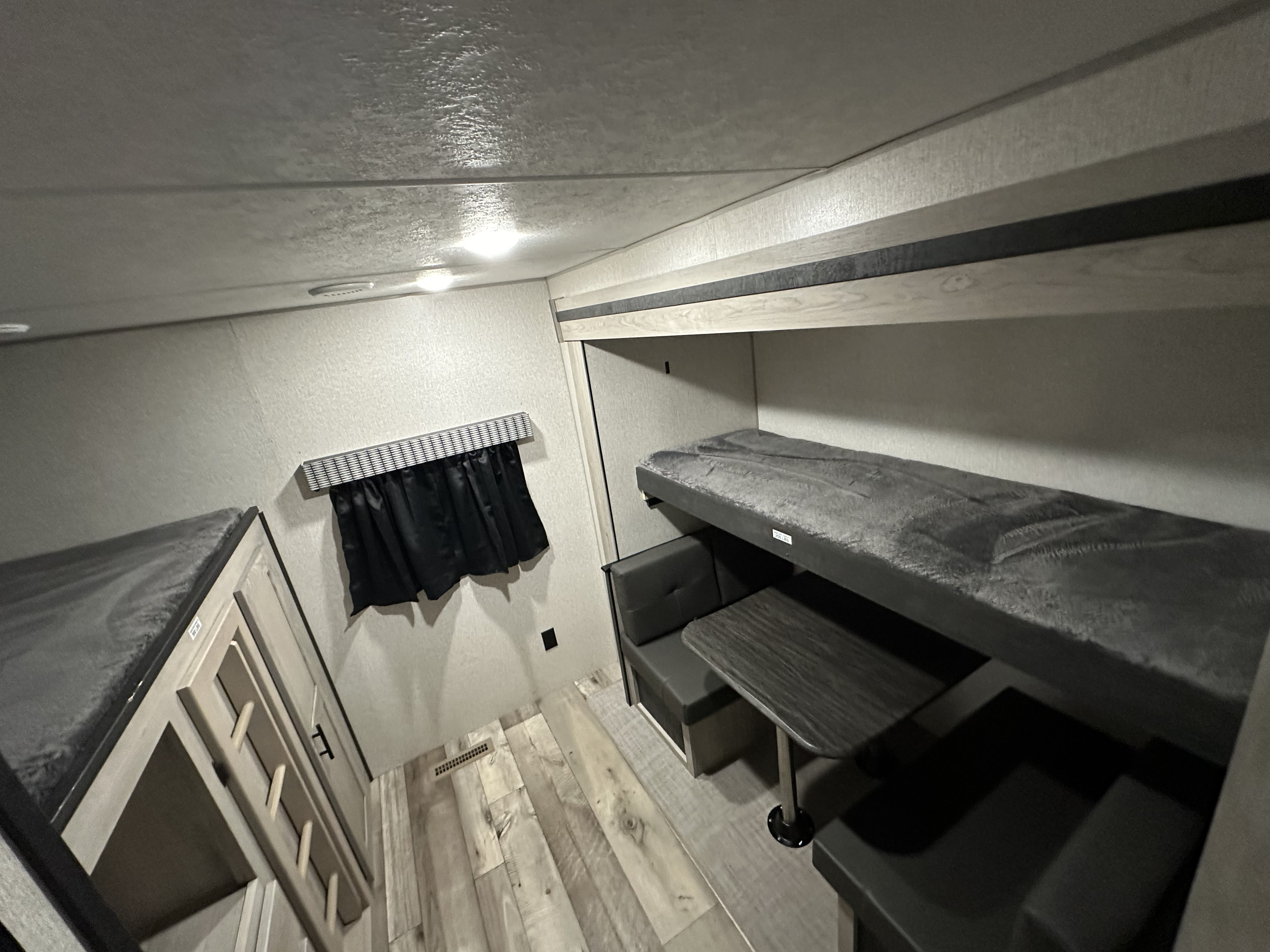 RV rental: Interior shows bunk beds, a dinette with table, and wood-patterned flooring in a clean, well-lit space.. KZ Connect 322BHK 2023