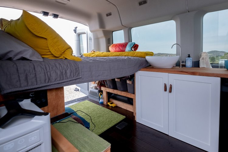 This RV rental offers a compact, cozy interior with an elevated bed, full sink, and clever storage for your travels.. Ford Transit Custom 2015