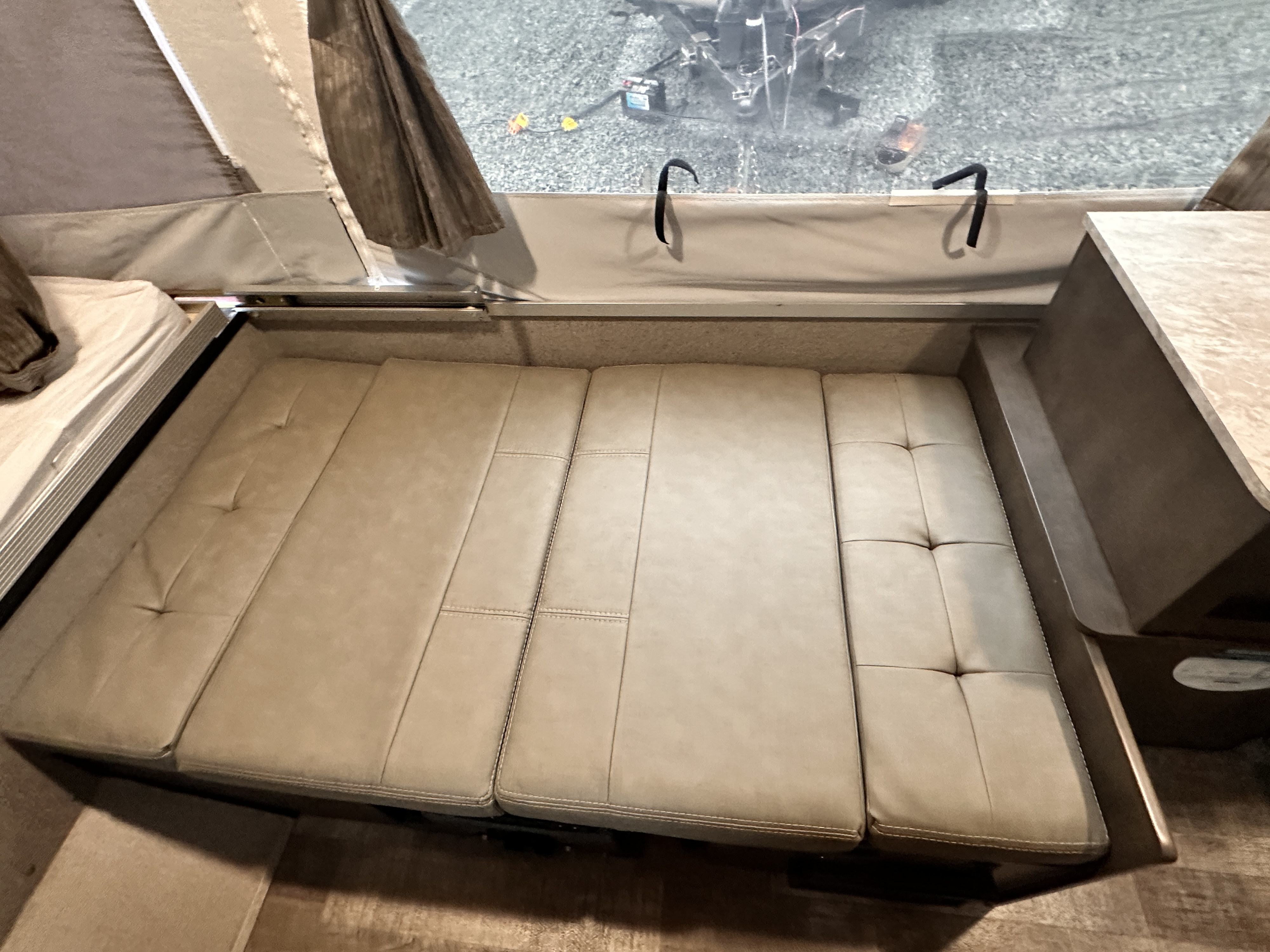 RV rental interior: View of a laid-out bed/seating area with cushions and a window, likely in a pop-up camper.. Forest River Rockwood Freedom 2020
