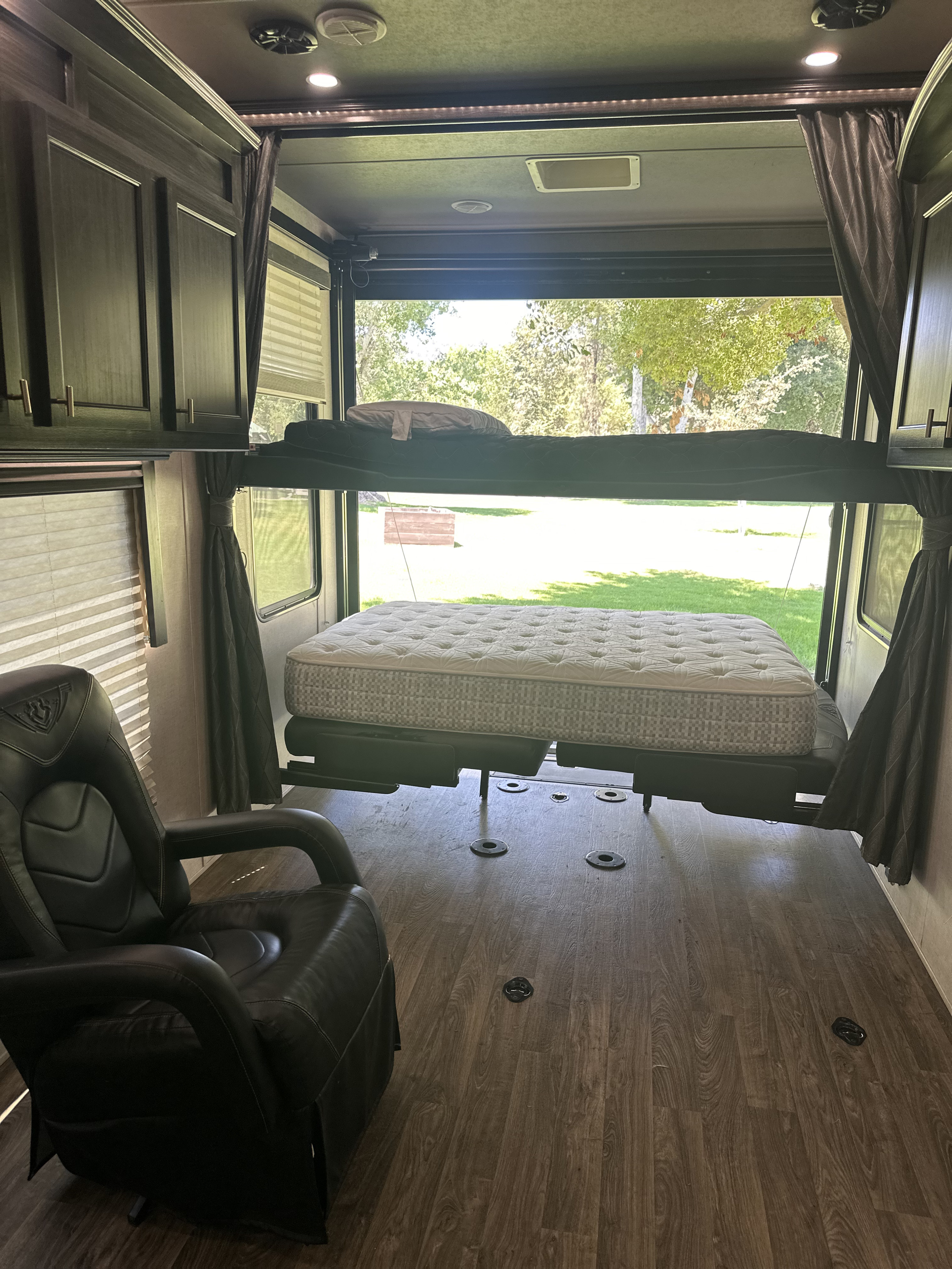 RV rental: Interior of a toy hauler featuring power bunk beds, lower bed, comfortable chair, and open view.. Eclipse Recreational Vehicles Attitude 2020