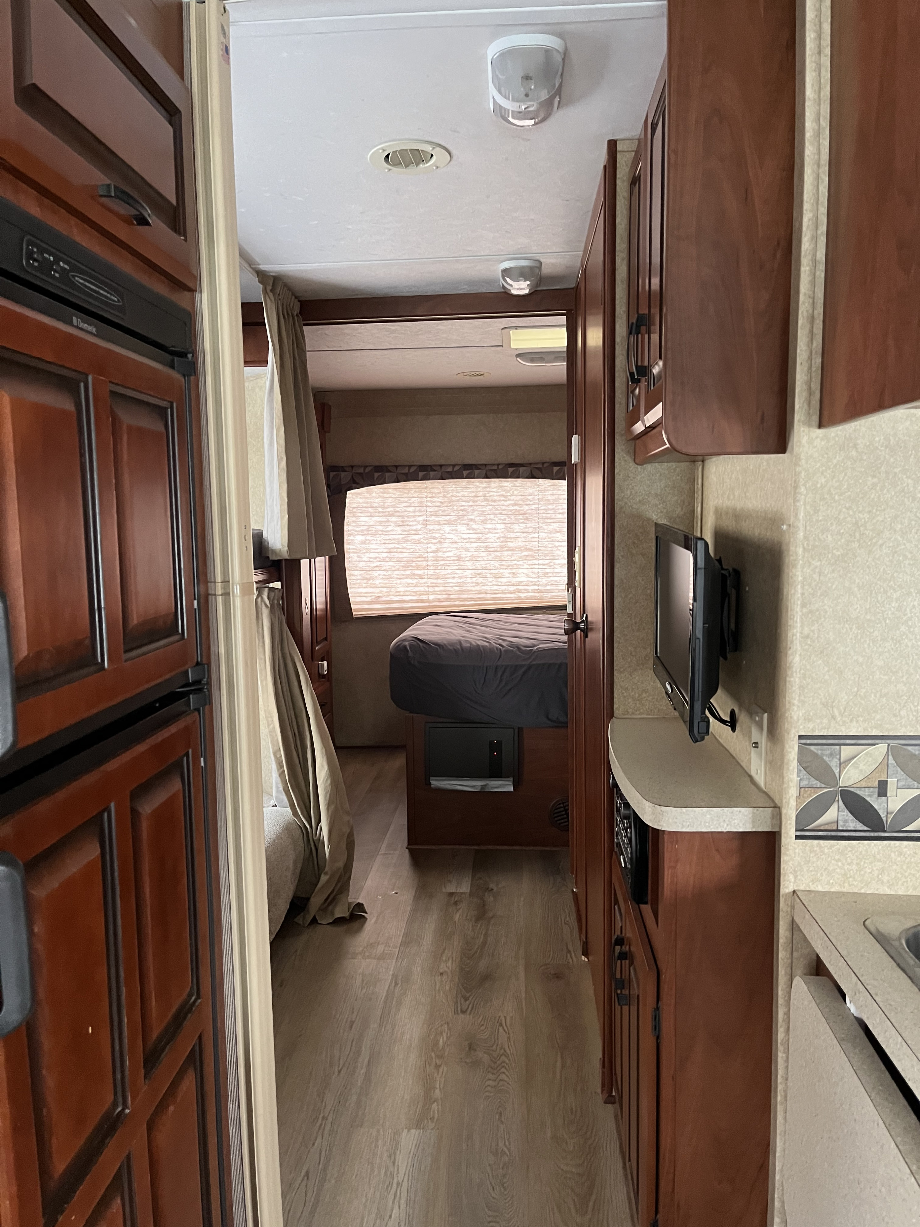 Compact RV rental interior featuring a cozy bedroom, kitchen, and ample storage, perfect for adventures.. Forest River Sunseeker 2013