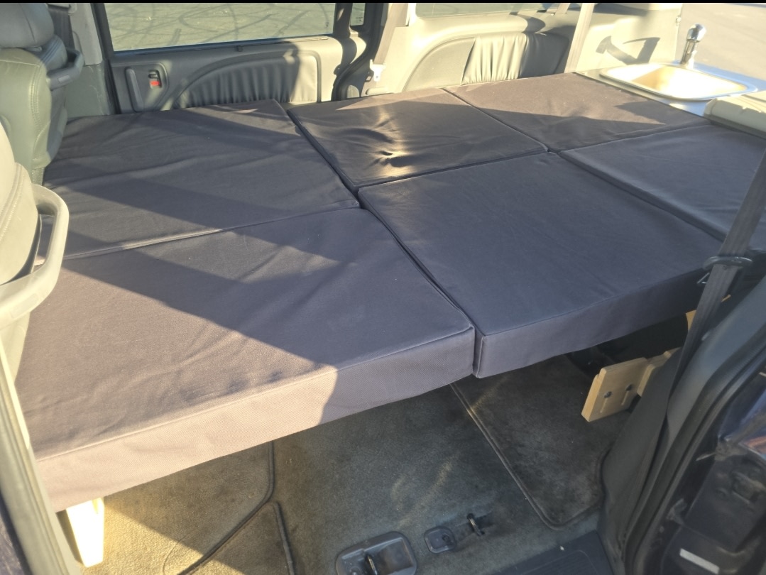 Minivan RV rental interior: multi-segment bed & compact kitchen for comfortable travel.. Odyssey Honda 2008