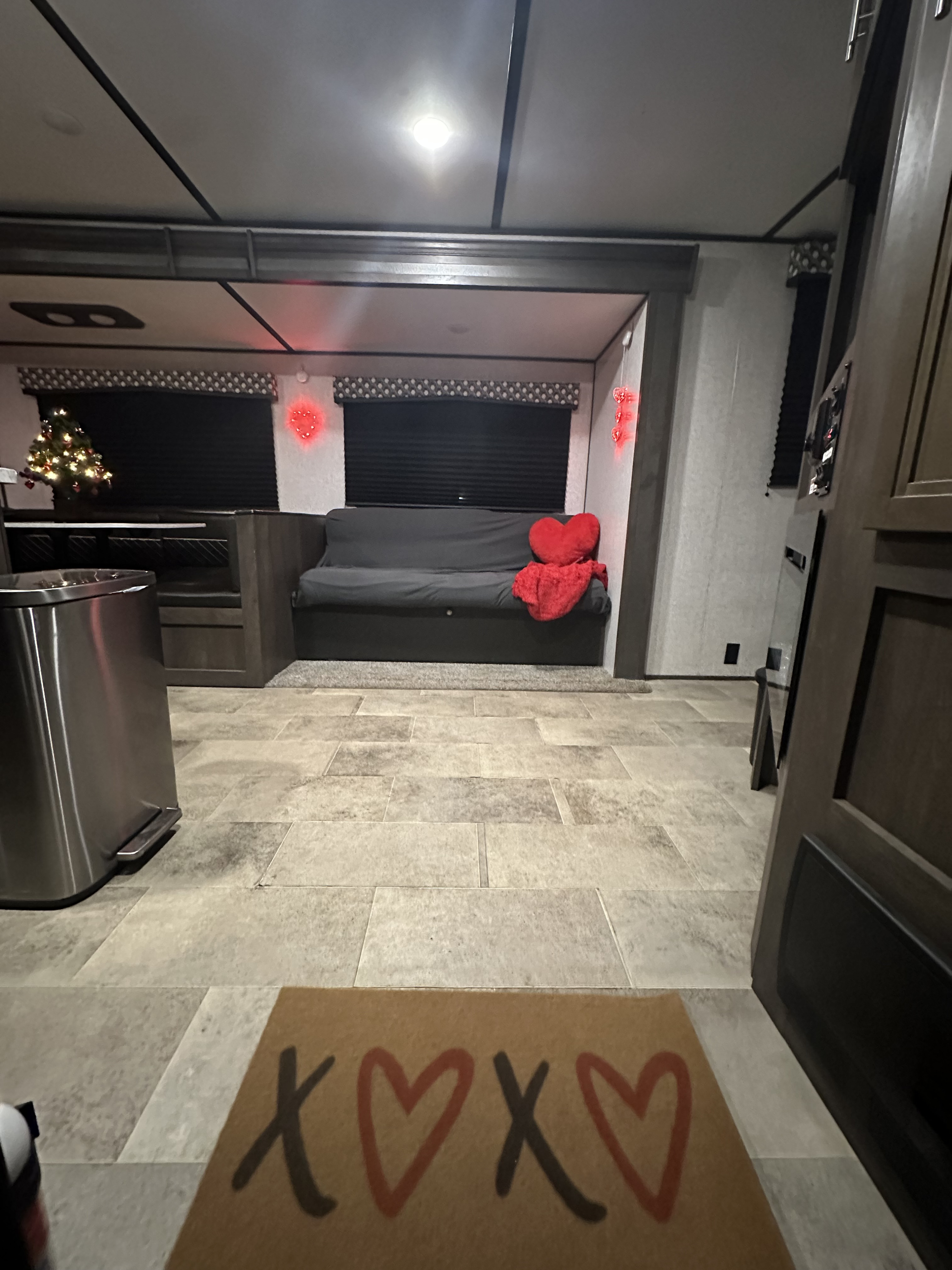 Experience a festive RV rental! This cozy interior features a decorated Christmas tree, charming heart lights, and a comfy living area.. Coleman CM337BH21 2021