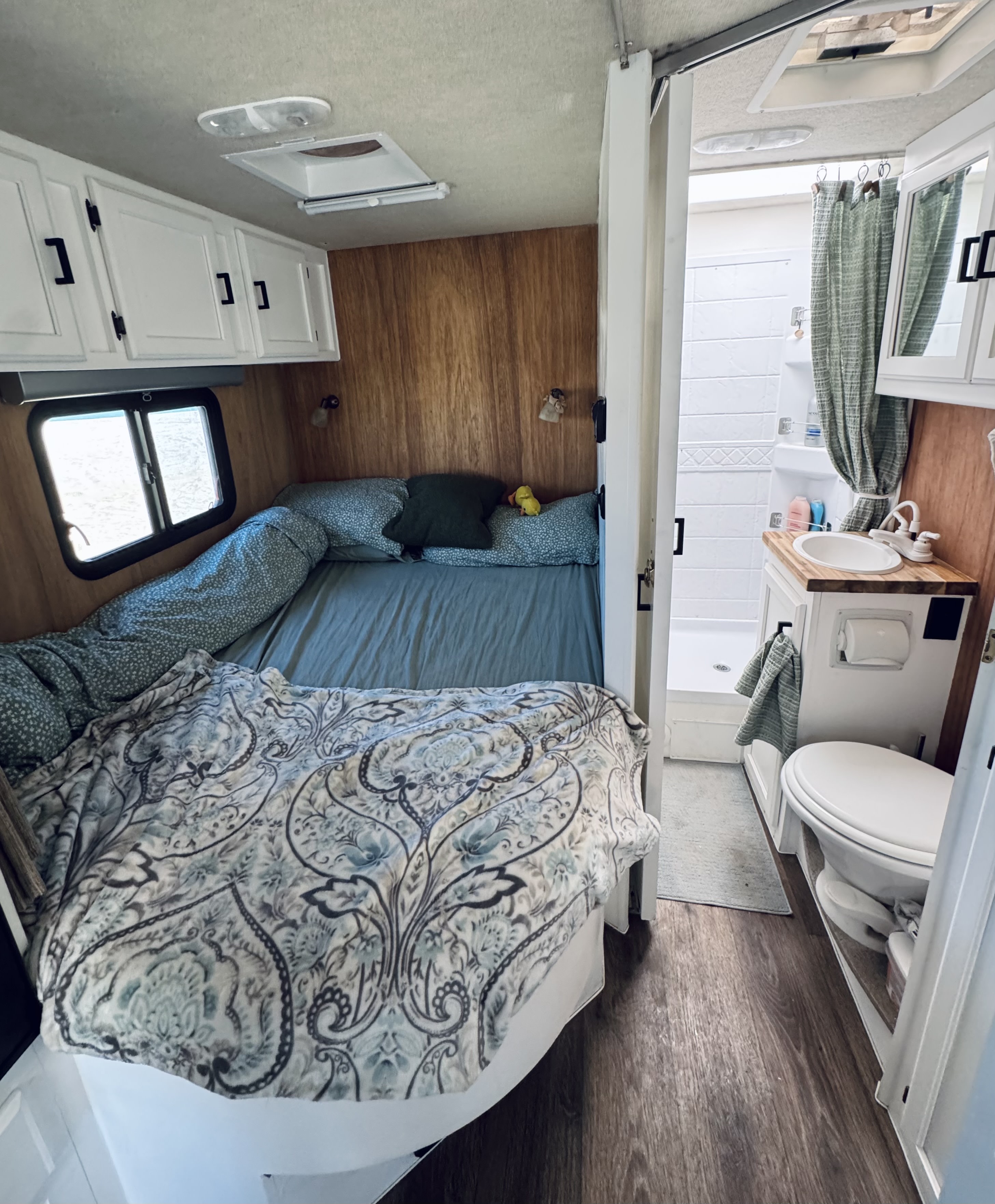 Cozy RV rental interior: comfortable bed, white cabinets, and a compact bathroom with shower.. Adventurer Adventurer Motorhome 2016