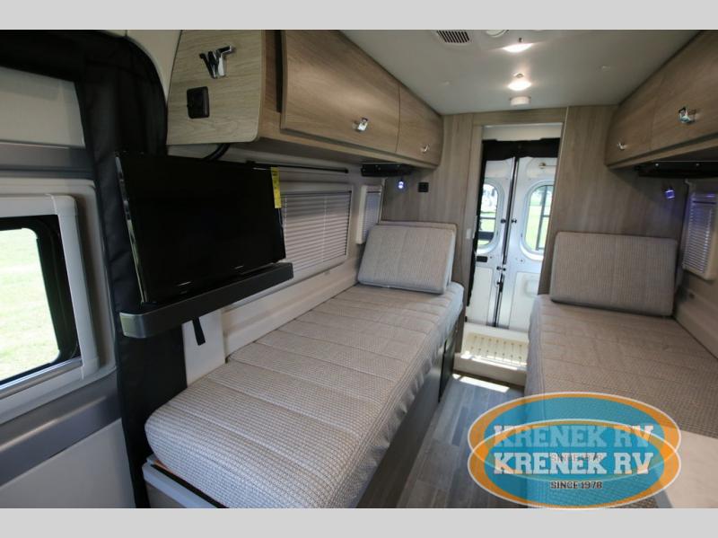 Step inside this RV rental: a modern travel van with cozy twin beds, flat-screen TV, and practical storage.. Winnebago Travato 2022