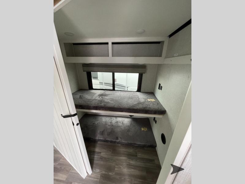 Cozy RV rental interior with bunk beds and storage, perfect for family adventures. Ideal for a travel trailer camper.. Highland Ridge RV Open Range Roamer 2024