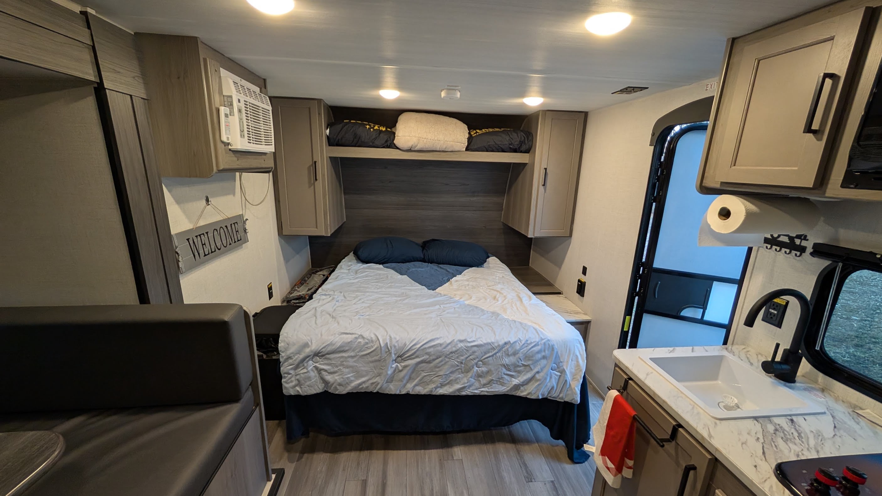 Inside this RV rental, you'll find a well-appointed interior featuring a bed, a compact kitchen with sink, and a dinette area for travel.. Keystone RV Hideout Sport 2024