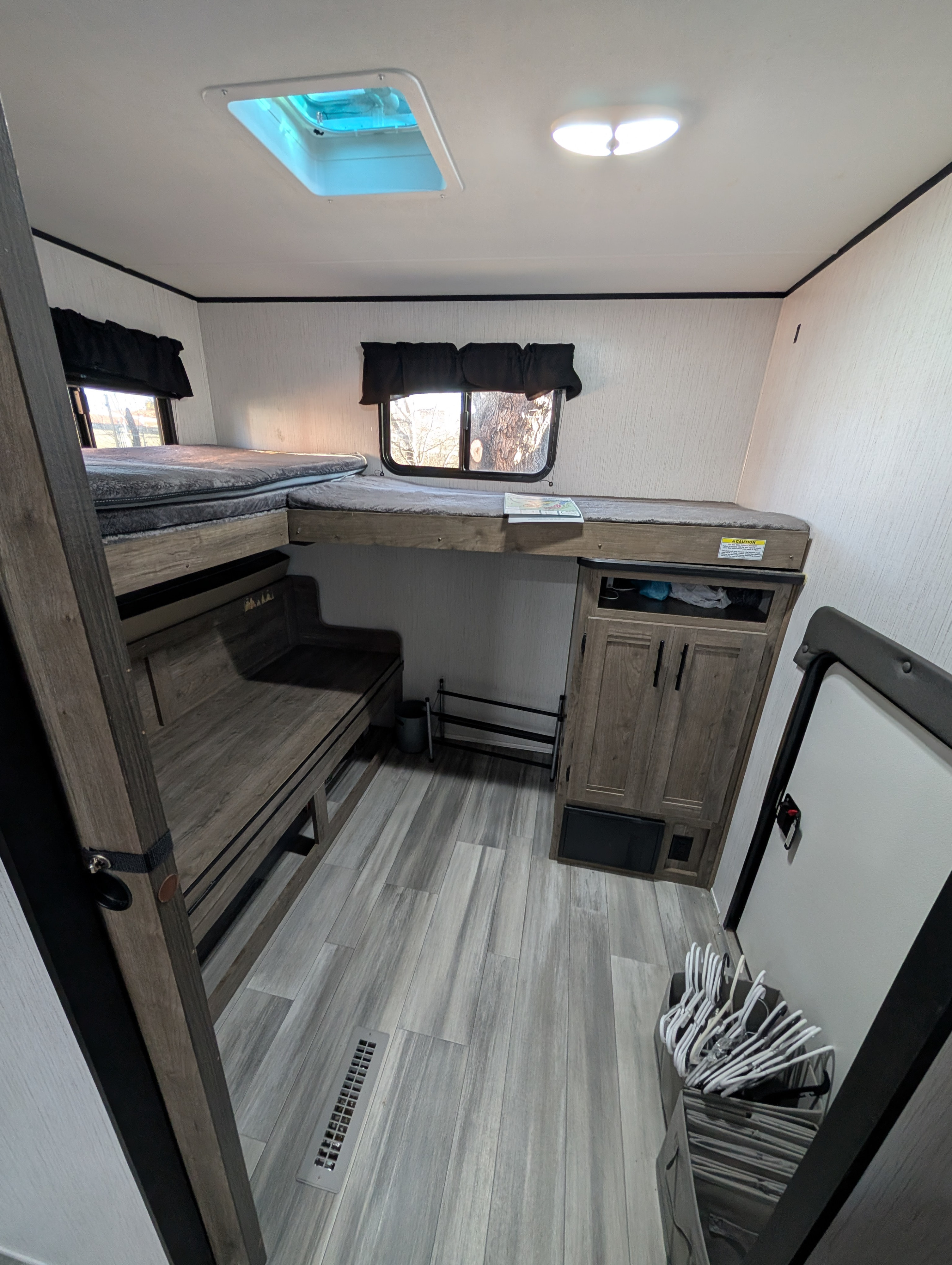 RV rental: Bunk beds, storage, and versatile seating maximize space in this cozy travel interior.. Heartland RVs Pioneer 2021