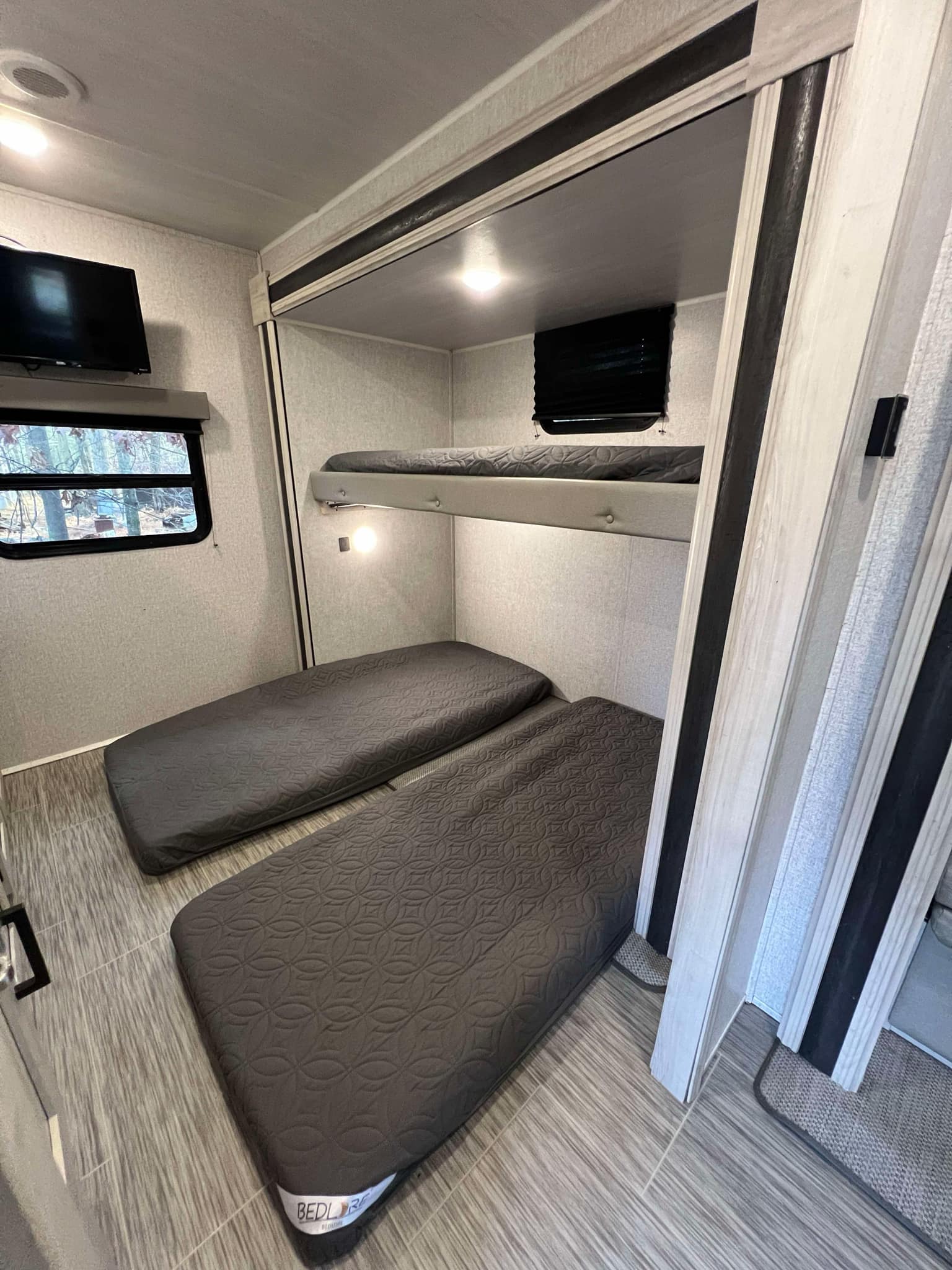 This RV rental's sleeping area features two bunk beds and two floor mattresses, offering ample space for guests.. East to West Silver Lake 2022