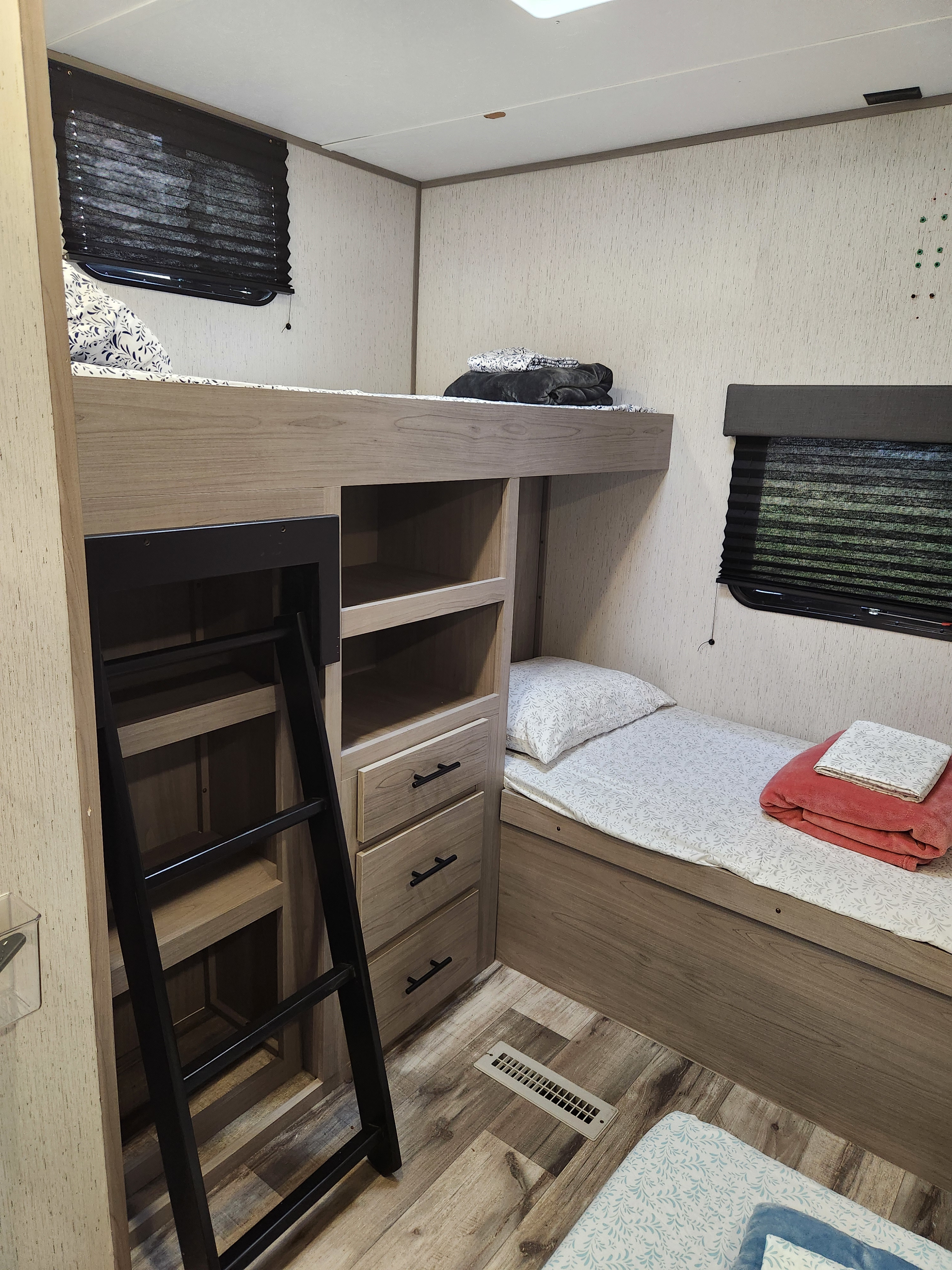 Cozy RV rental interior featuring modern bunk beds, ample storage, and comfortable sleeping arrangements for your adventure.. Dutchmen Coleman 2022