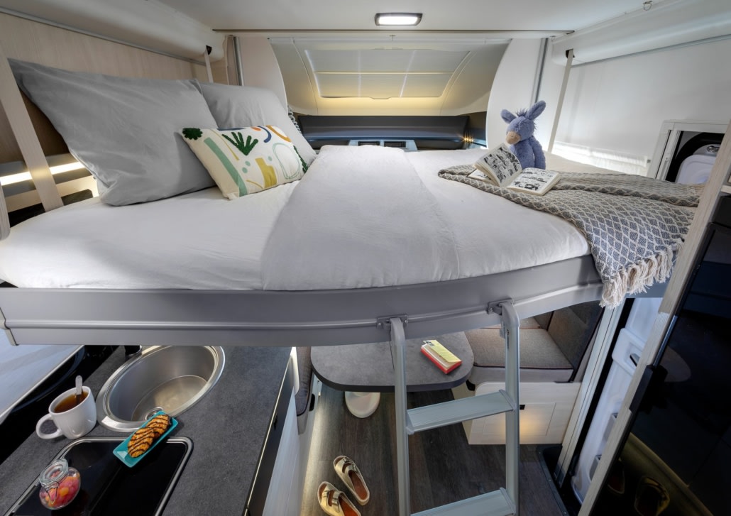 RV rental interior: a cleverly designed compact living space with a loft bed, kitchen, and dining area.. CHAUSSON 788 TITANIUM ULTIMATE 2024