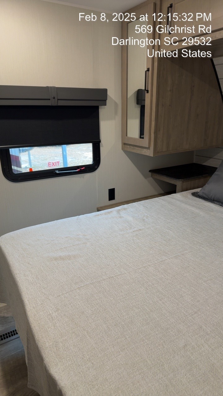 Spacious RV rental bedroom with a comfy bed, overhead storage, and an emergency exit window. Perfect for your next trip!. Forest River Puma 2024