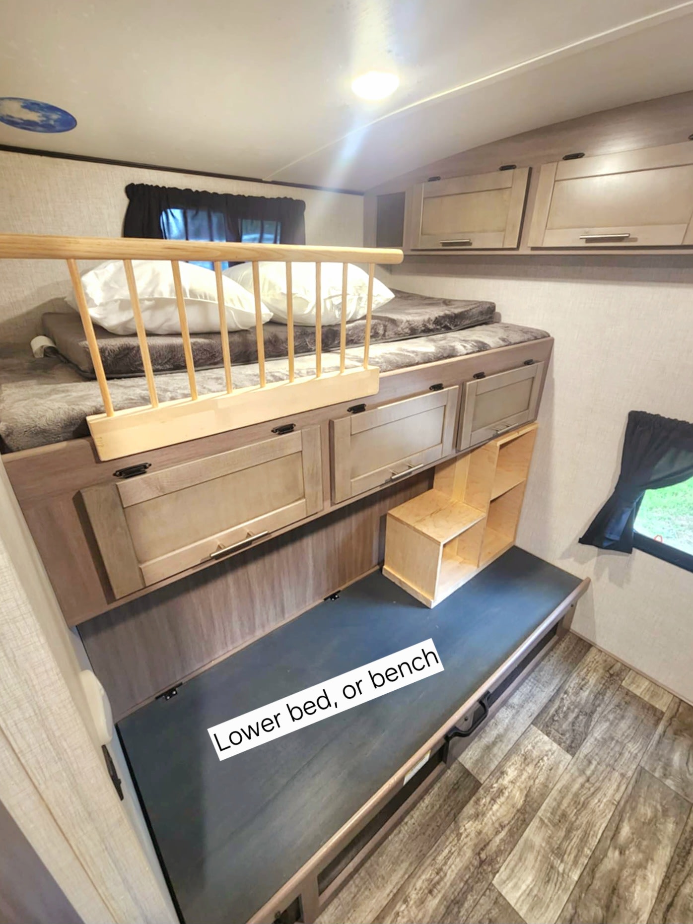 RV rental bunk beds: upper bed with rail, convertible lower bed/bench, and built-in storage.. Crossroads RV Sunset Trail 2022