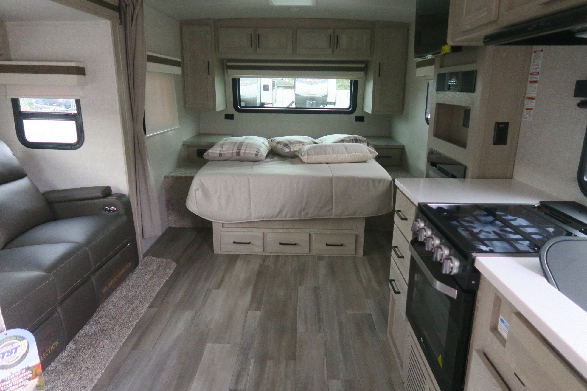 Modern RV interior showcasing a cozy bedroom, kitchen, and living area. Ideal for your next rv rental journey.. Forest River Rockwood Mini Lite 2022
