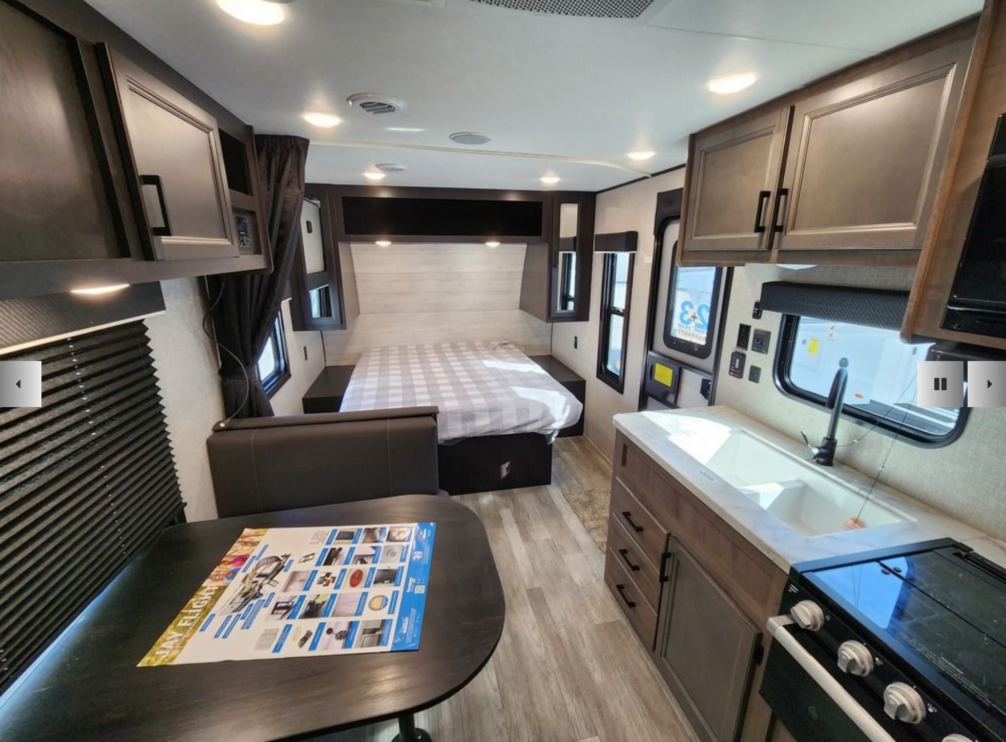 RV rental interior: modern design with a kitchen, bed, and dinette. Perfect for your next camper adventure.. Jayco Jay Flight 2023