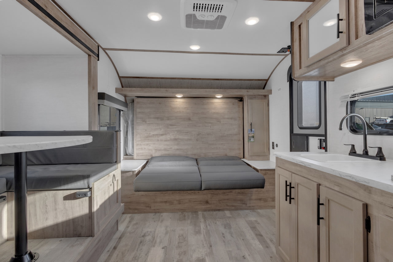 Spacious RV rental interior featuring a convertible bed, dinette, and full kitchen, perfect for your next adventure.. Gulf Stream Kingsport 192DS 2025