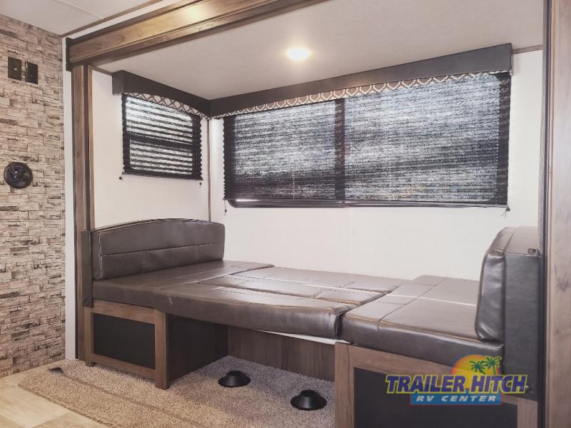 This RV rental features a versatile dinette with dark blinds, converting into a bed for compact sleeping.. Avenger 26BBS 2021