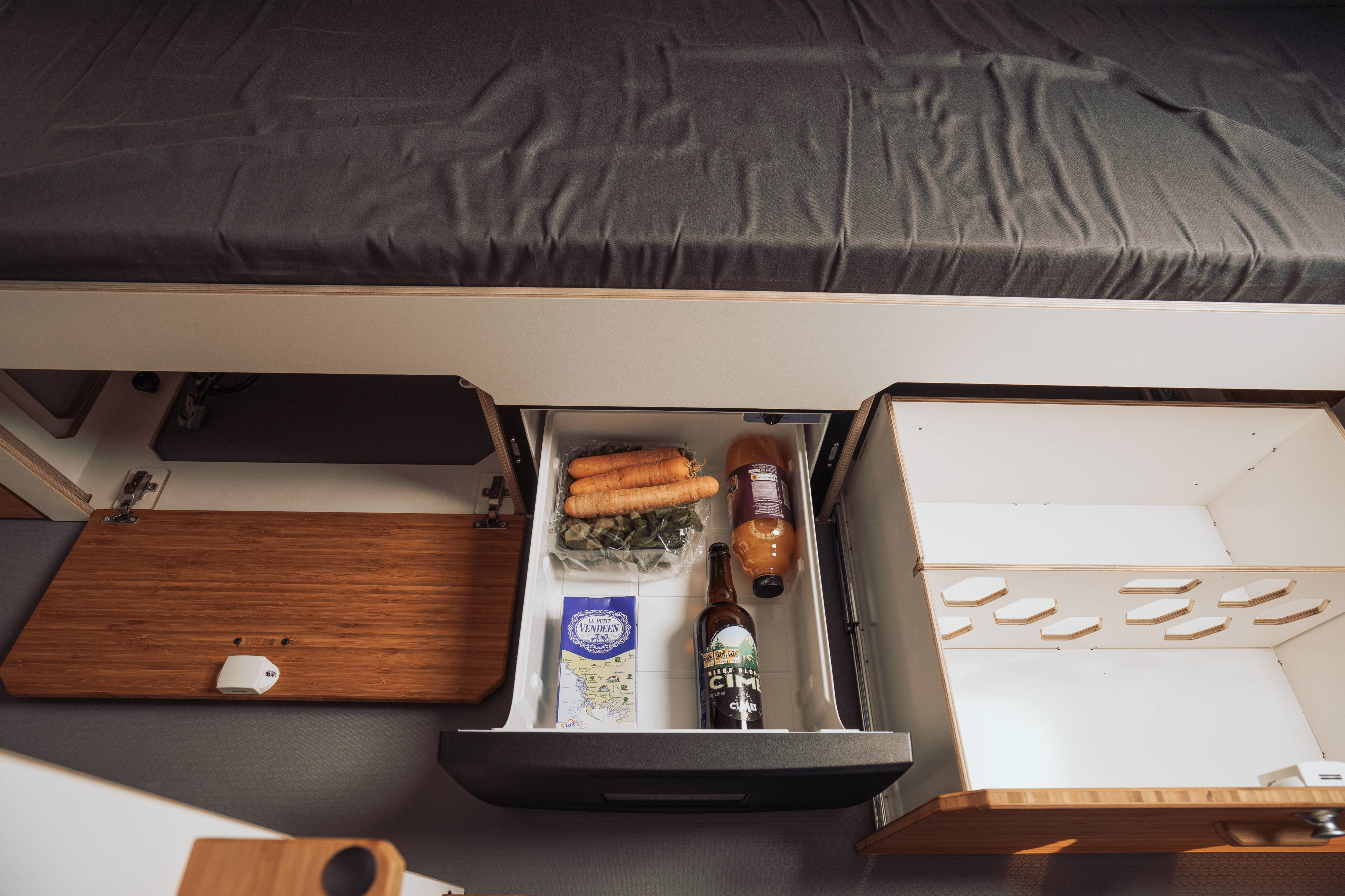 RV rental: Under-bed storage features a pull-out fridge with carrots & beer, plus smart compartments.. Renault Trafic 2025