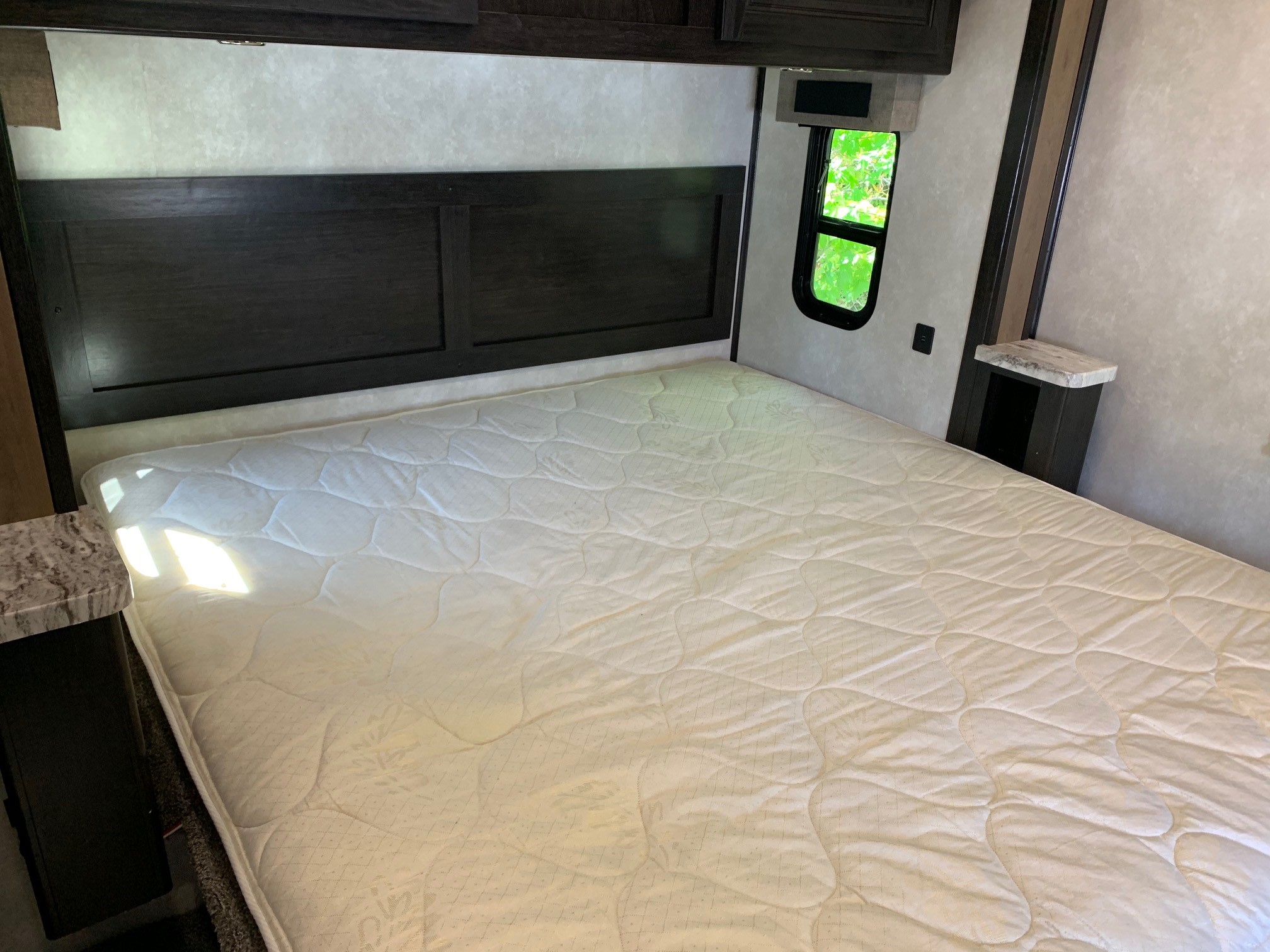 Spacious RV rental bedroom with a comfy queen bed and natural light, perfect for your next trip.. Forest River Fr3 2021