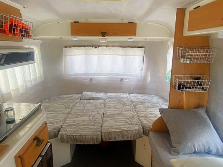 Step inside this comfortable RV rental, featuring a flexible bed, kitchen counter, and handy storage baskets.. Casita Freedom Deluxe 1994