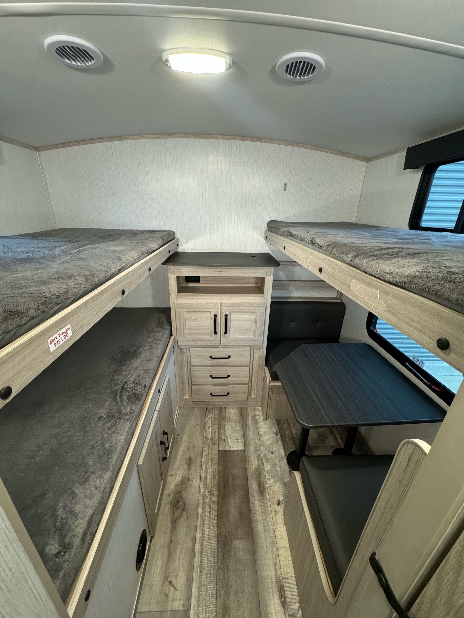 This RV rental features a well-equipped bunkhouse with cozy beds, a dinette, and built-in storage.. Heartland Sundance 2023