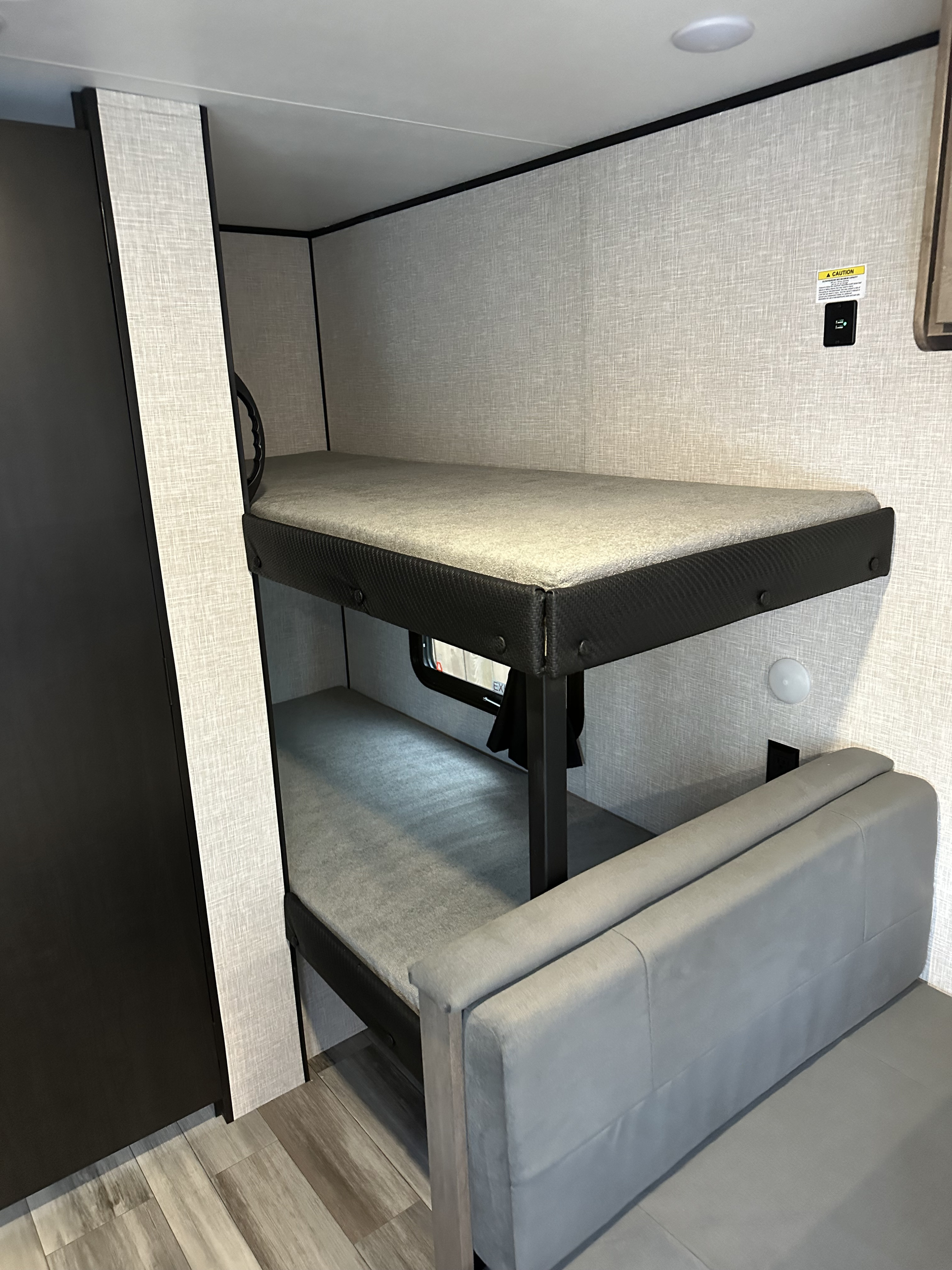 RV rental interior features bunk beds, a grey sofa, and practical amenities for comfortable travel.. Jayco Jayflight SLX 175BHW Baja 2025