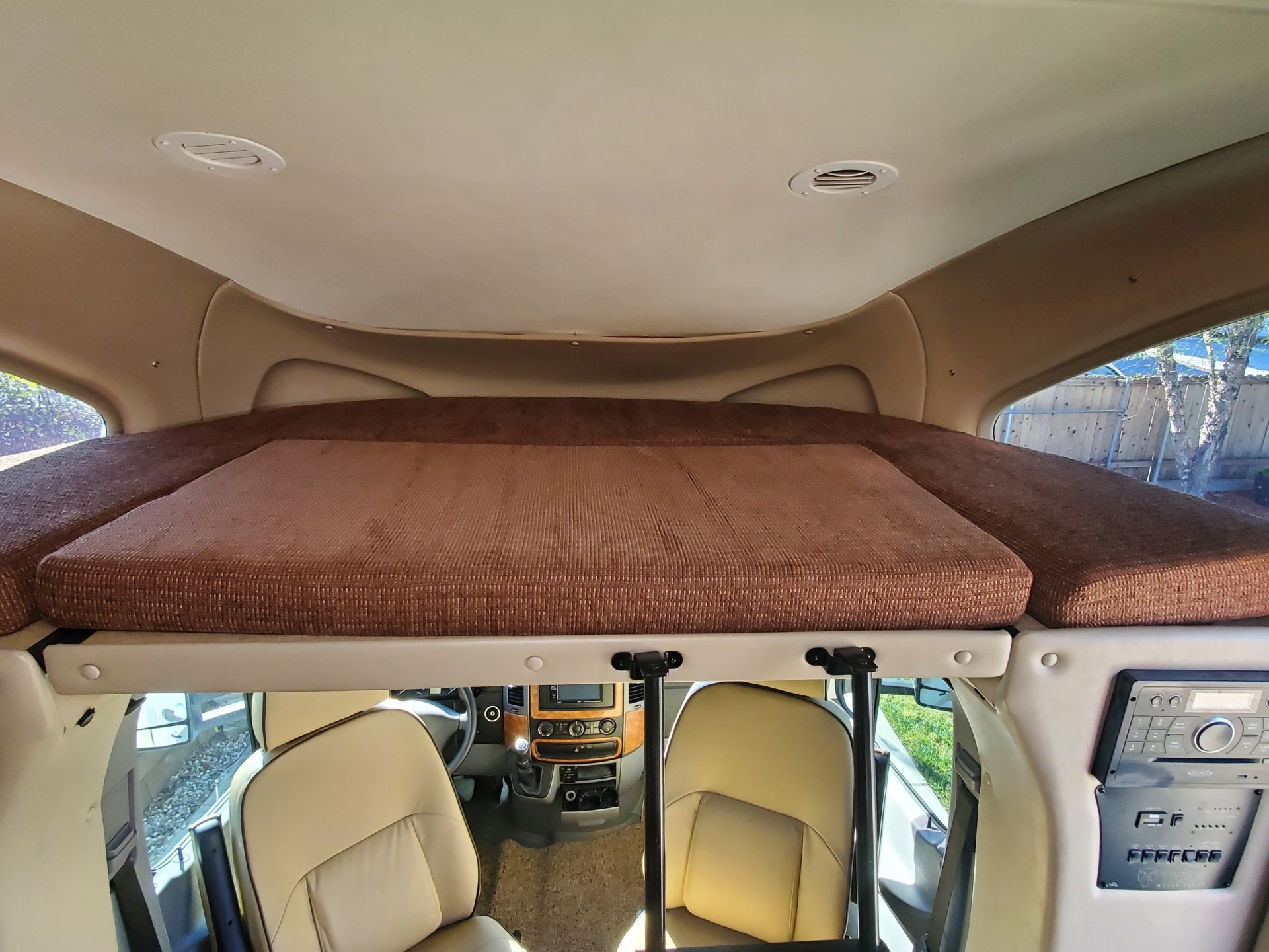 RV rental interior: Spacious overhead bunk/bed provides comfortable sleeping space above the driver's cabin.. Thor Siesta 2016