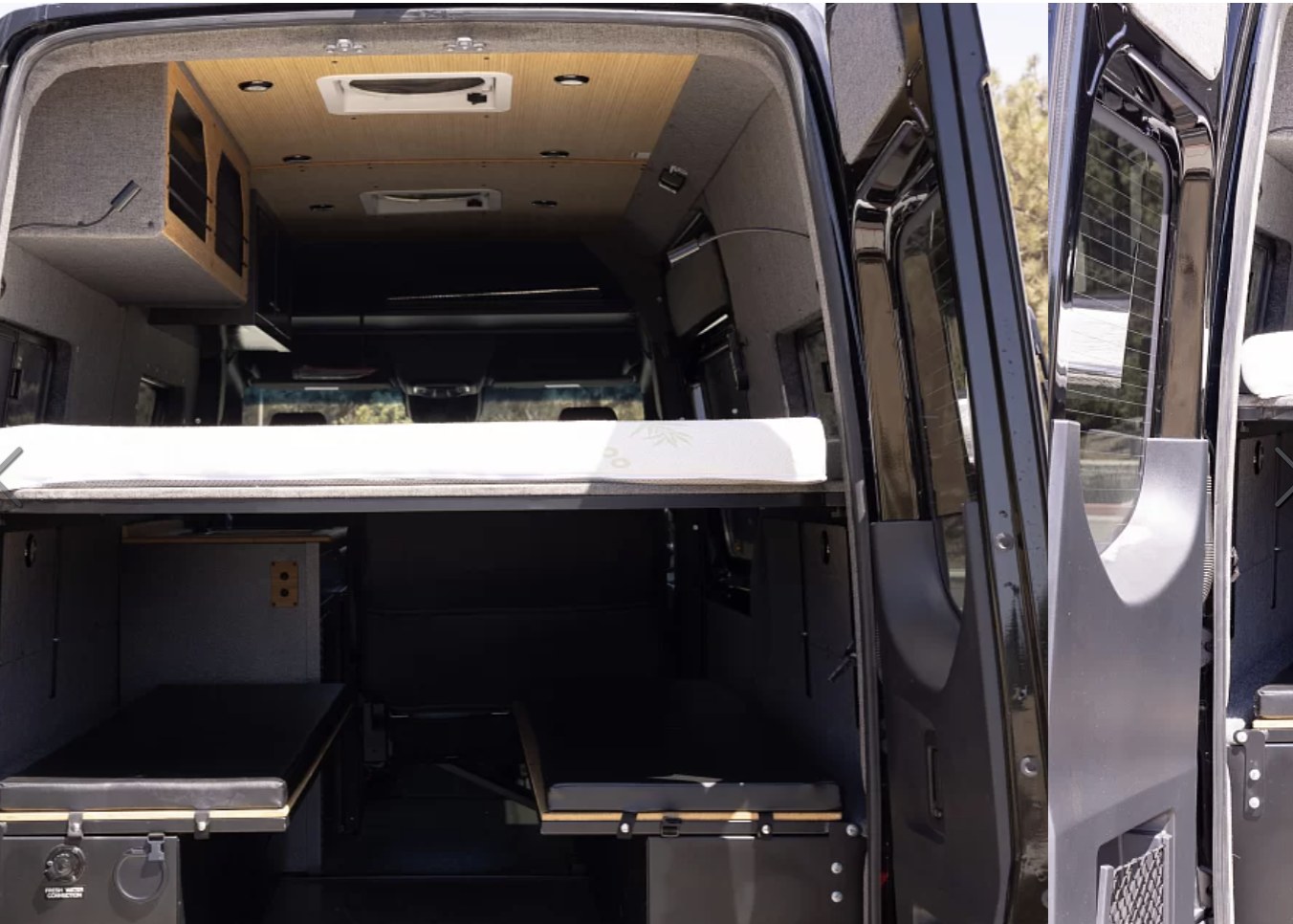 Inside an RV rental: a flexible camper van layout featuring a raised bed, convertible seating, and storage options.. Vanworks Switchback 4D 144 2022