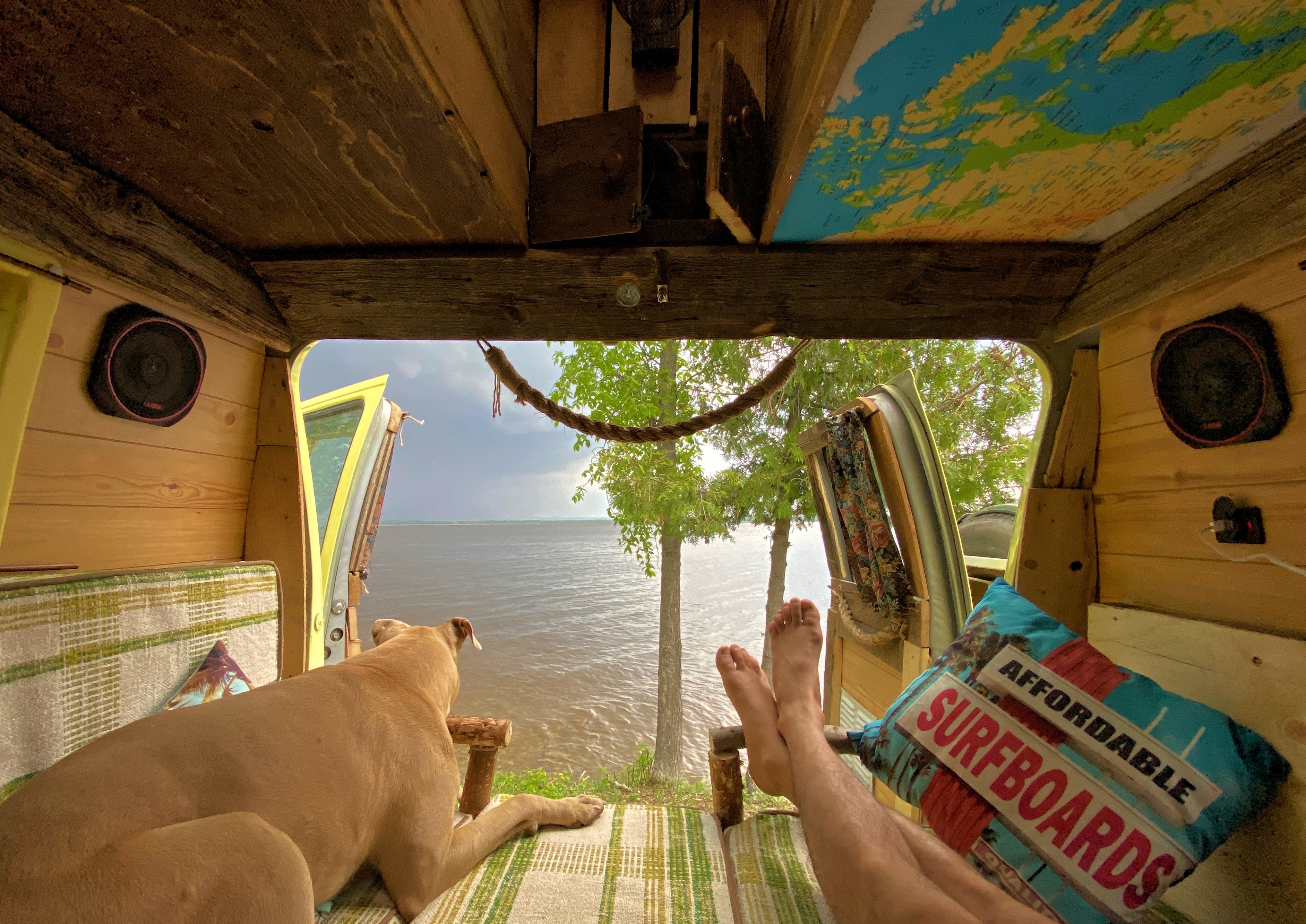 Tranquil RV rental escape: dog & feet up, enjoying serene lake views from a cozy, custom interior.. Ford Econoline Club Wagon 1985
