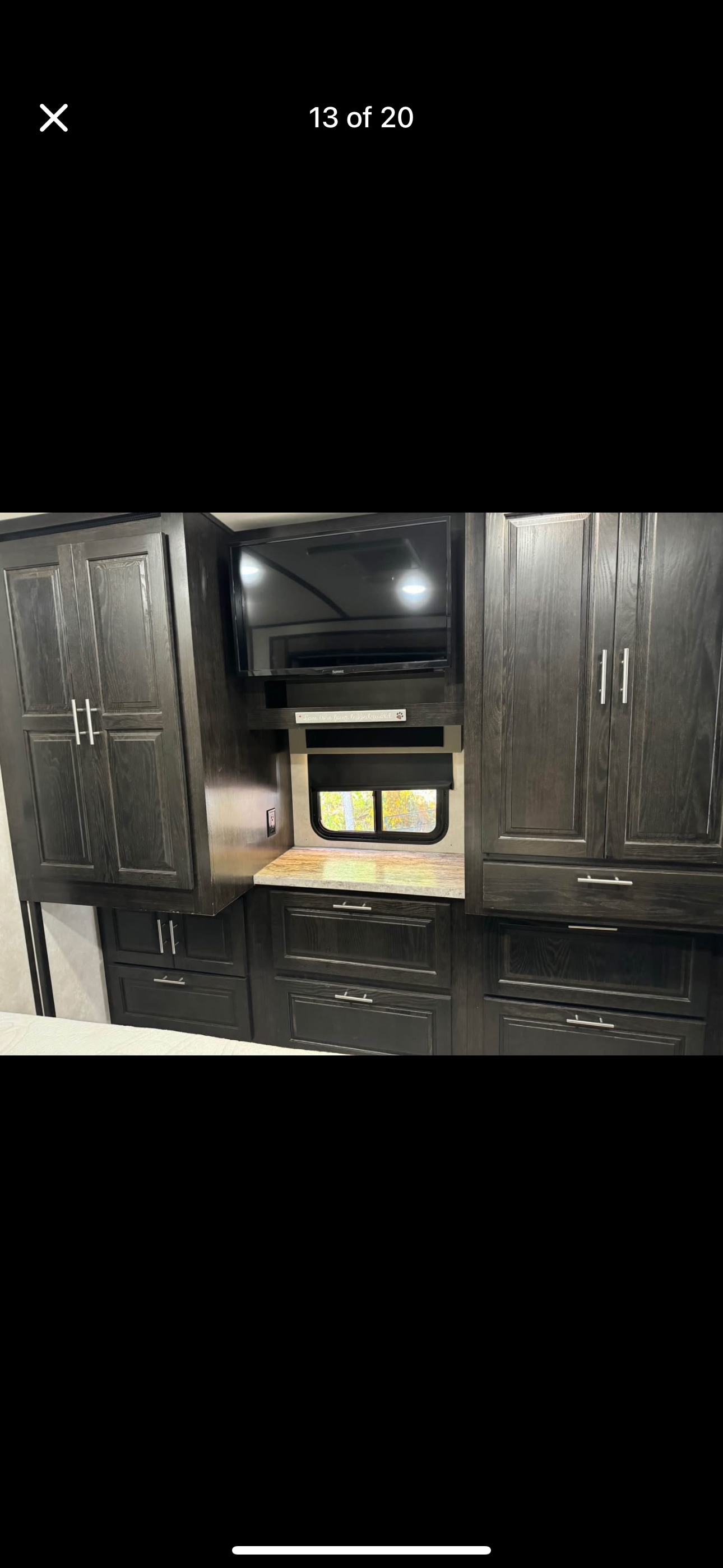 Discover this RV rental's functional interior: dark wood cabinetry, wall-mounted TV, and window.. Forest River FR3 34DS 2020