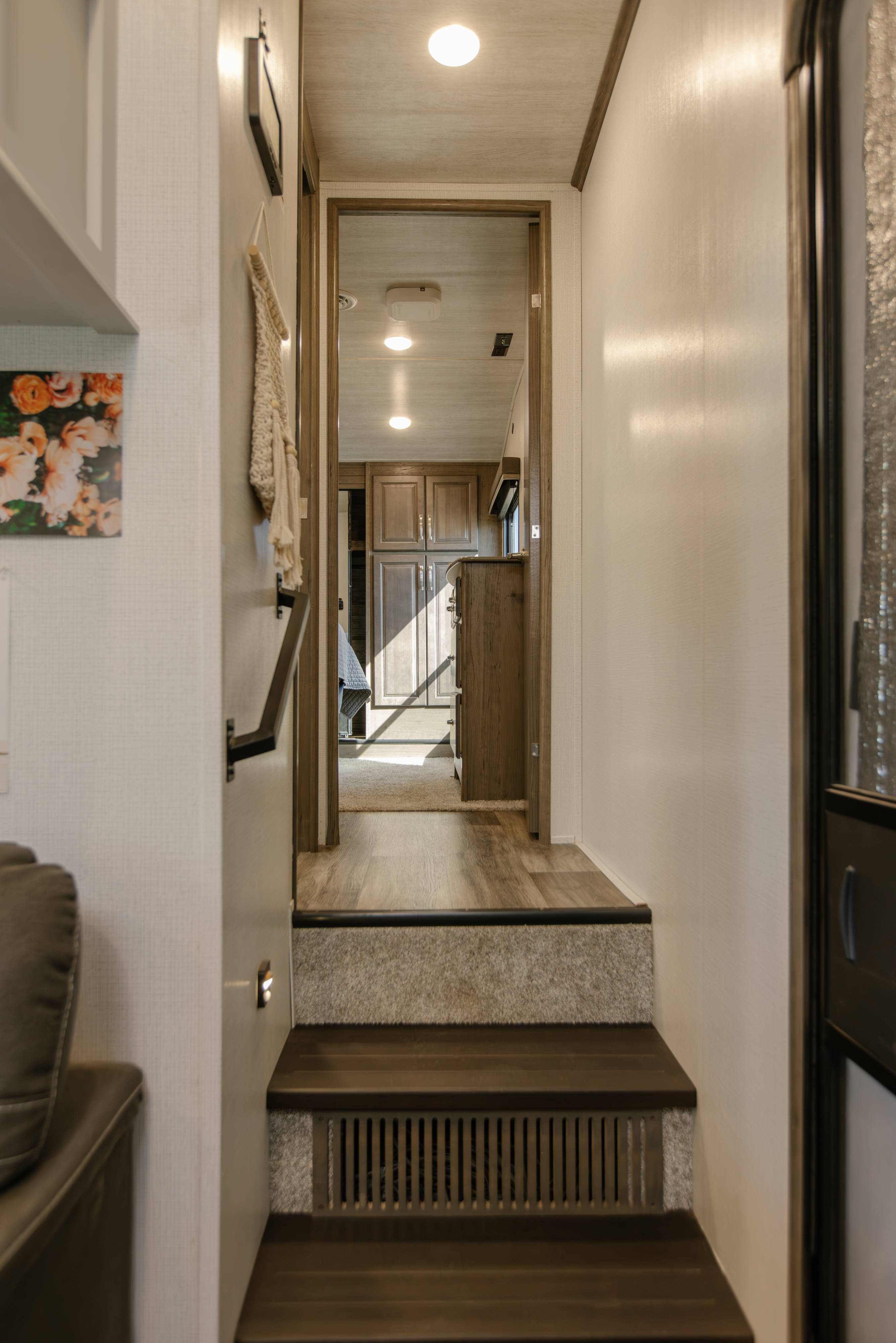 Discover this inviting RV rental interior: a bright hallway and modern stairs connect comfortable living spaces.. Keystone Cougar 2022
