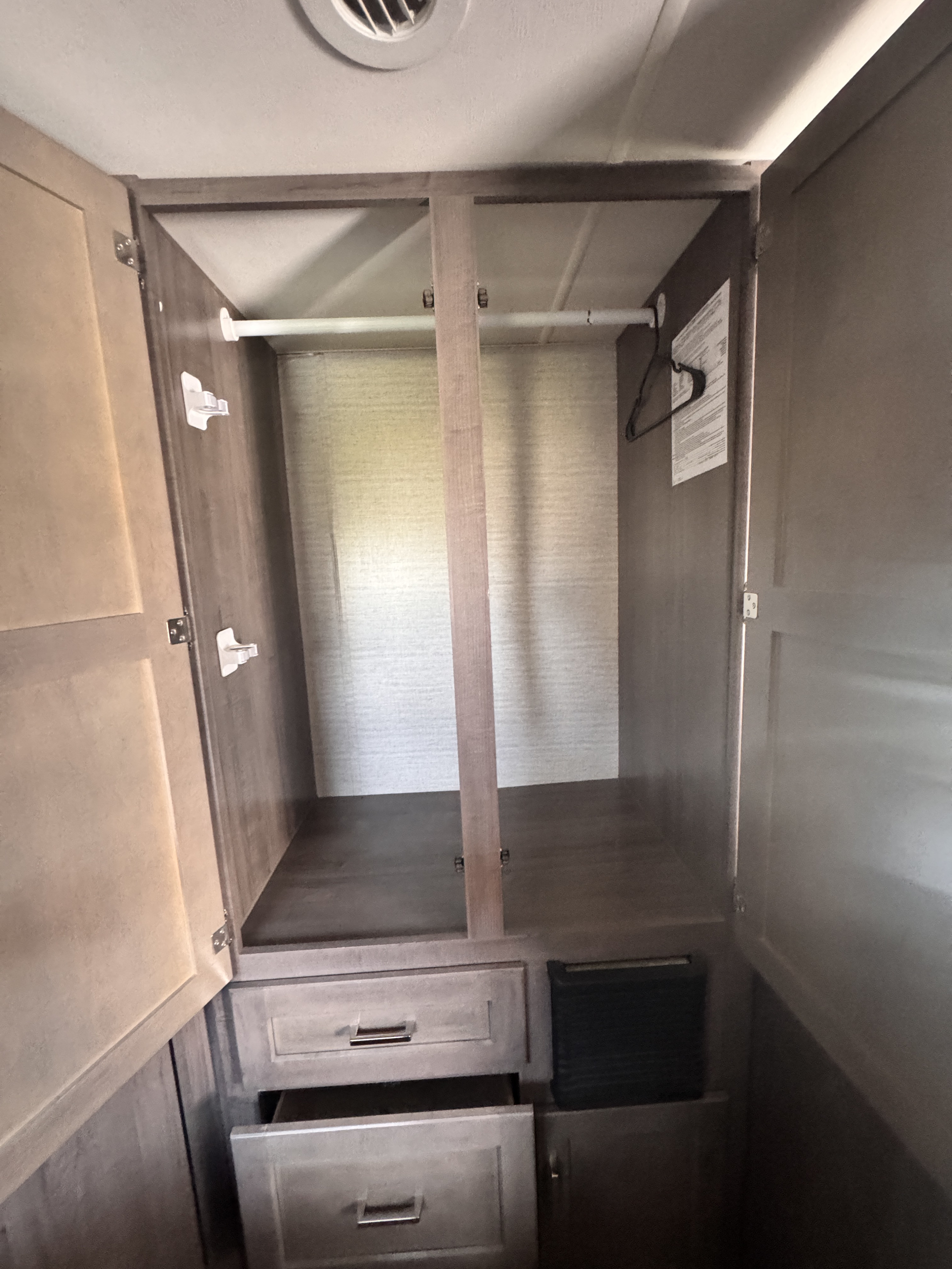 This RV rental features a practical wardrobe with hanging space, divided sections, and multiple drawers for storage.. Winnebago Minnie Winnie 2020