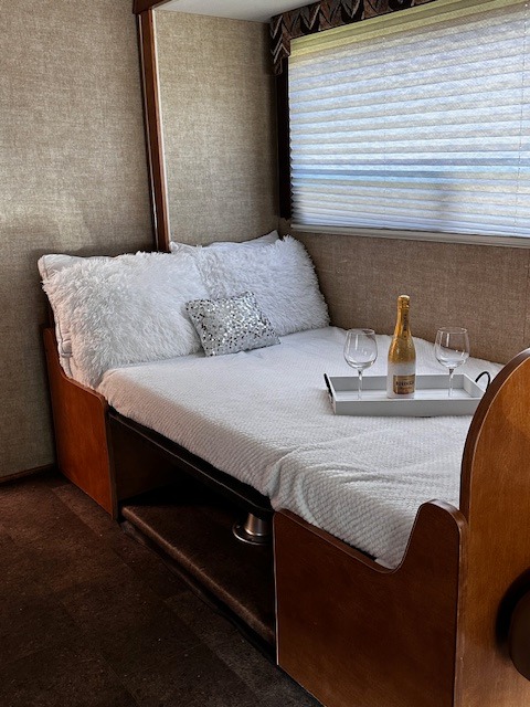 Cozy RV rental bed setup with champagne tray for a relaxing getaway.. Winnebago Minnie Winnie 2020
