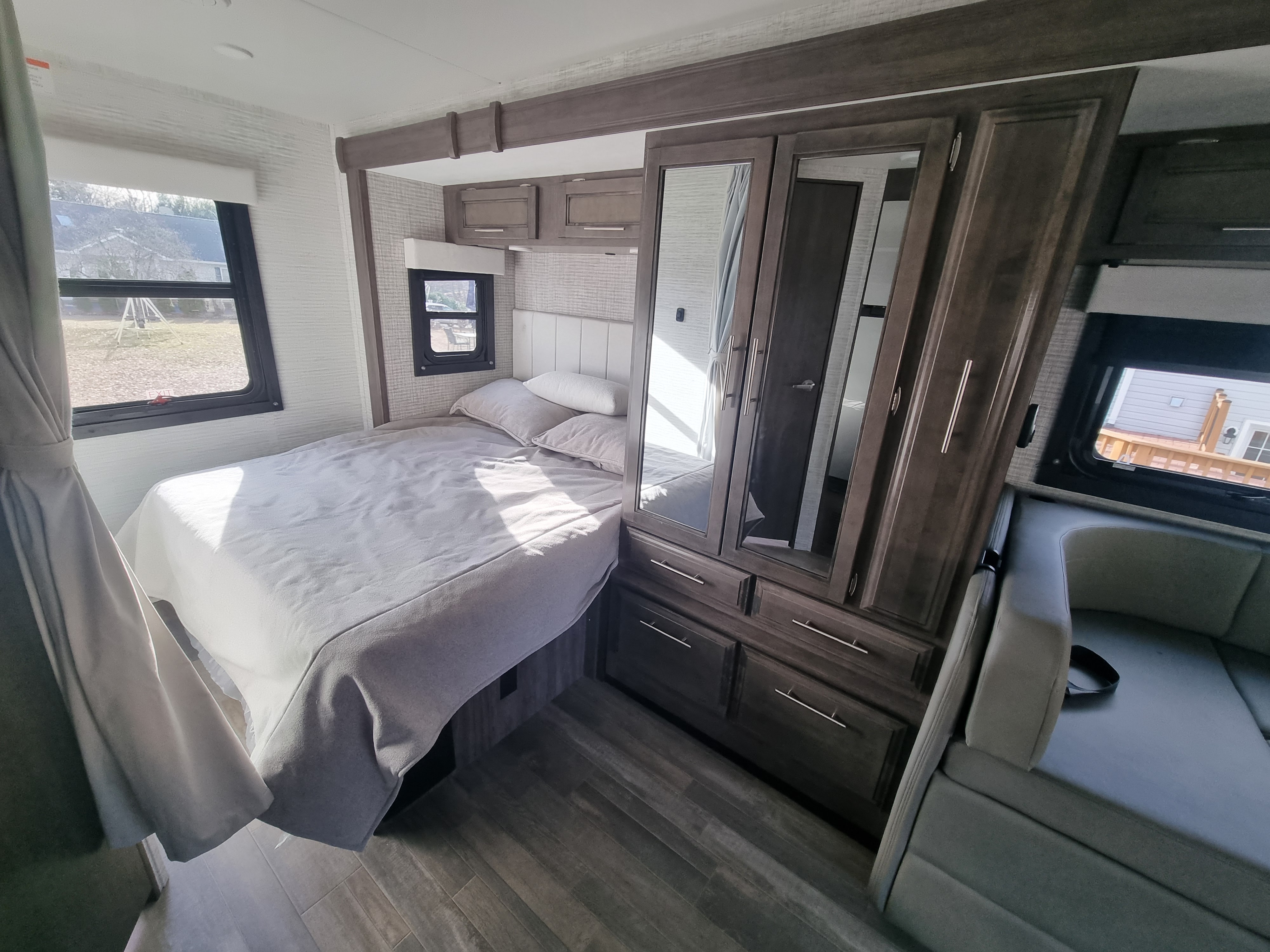 Modern RV rental bedroom featuring a comfortable bed, large mirrored wardrobe, and natural light.. Entegra Qwest SE 2025 Qwest 2025 Mercdes-Benz 2025